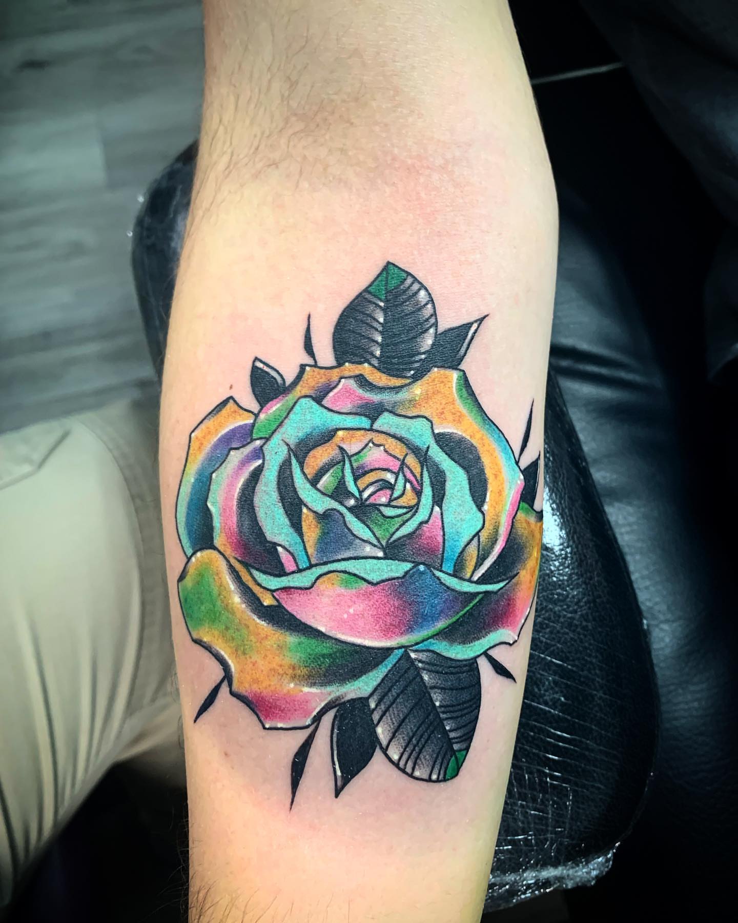 Rainbow rose new school tattoo on the forearm by Trevor Sibary