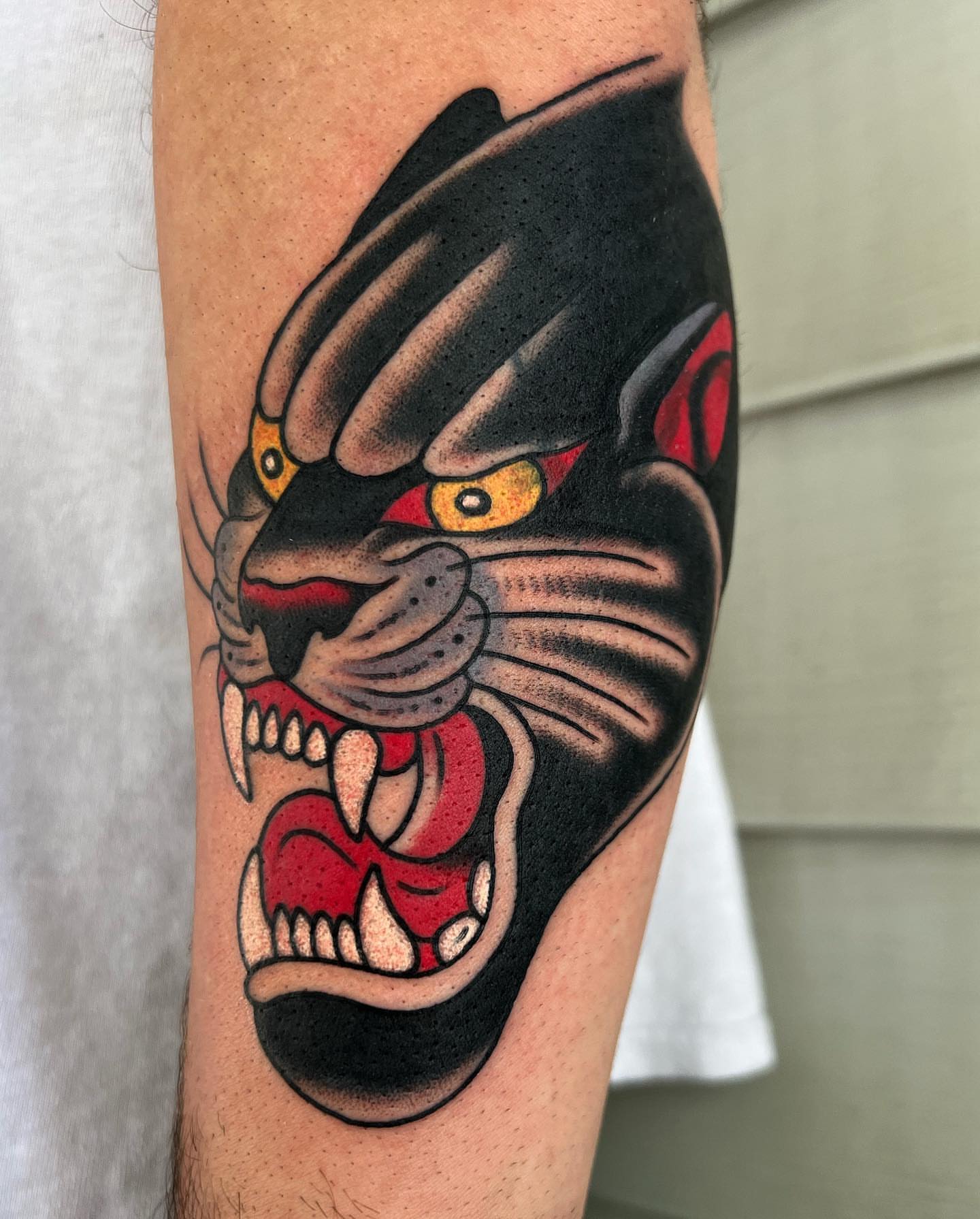 Panther American traditional tattoo on the forearm by Daniel Mesen