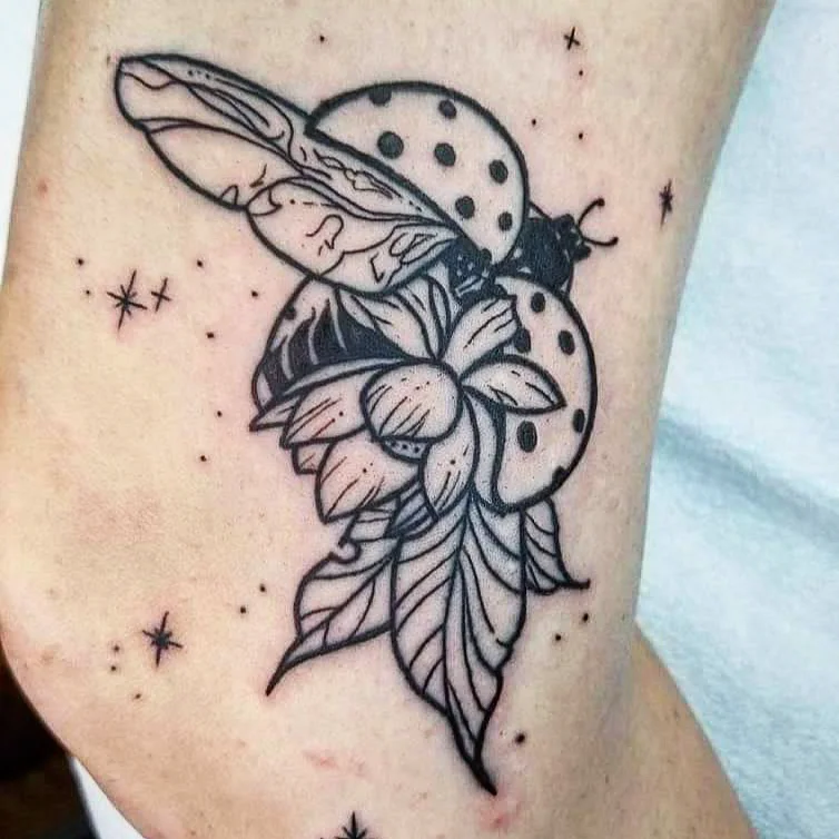 Ladybug and flower dotwork tattoo on the forearm by Nadine ☥