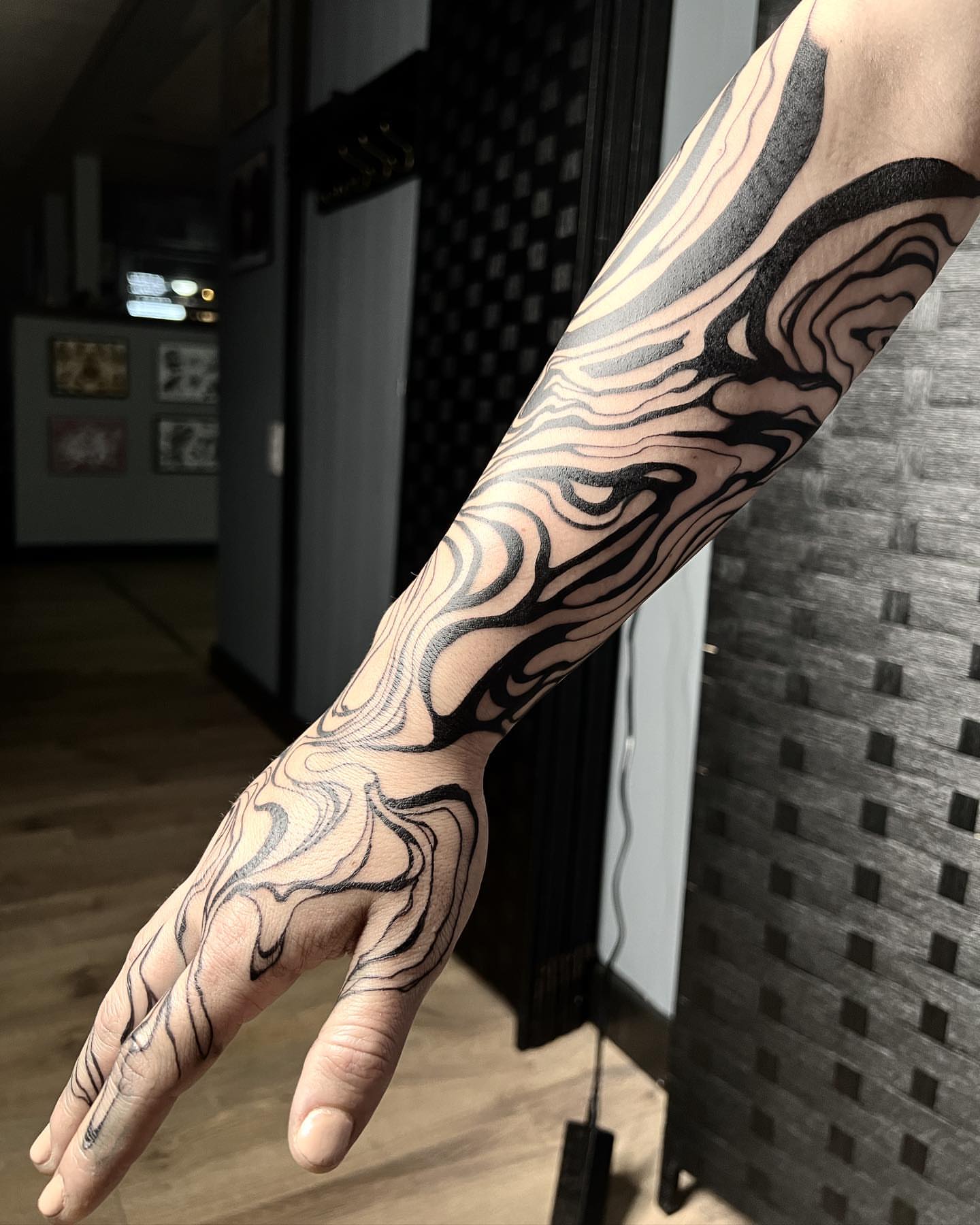 Abstract swirls black and grey tattoo on the hand by Emily Jestine Francis