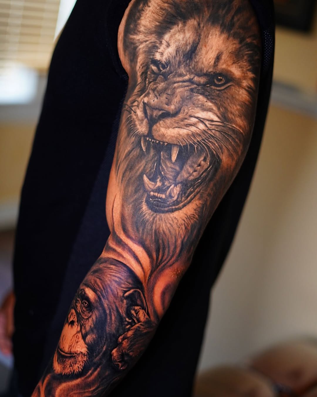 Lion and chimpanzee portrait sleeve realism tattoo on the forearm by David Gordon
