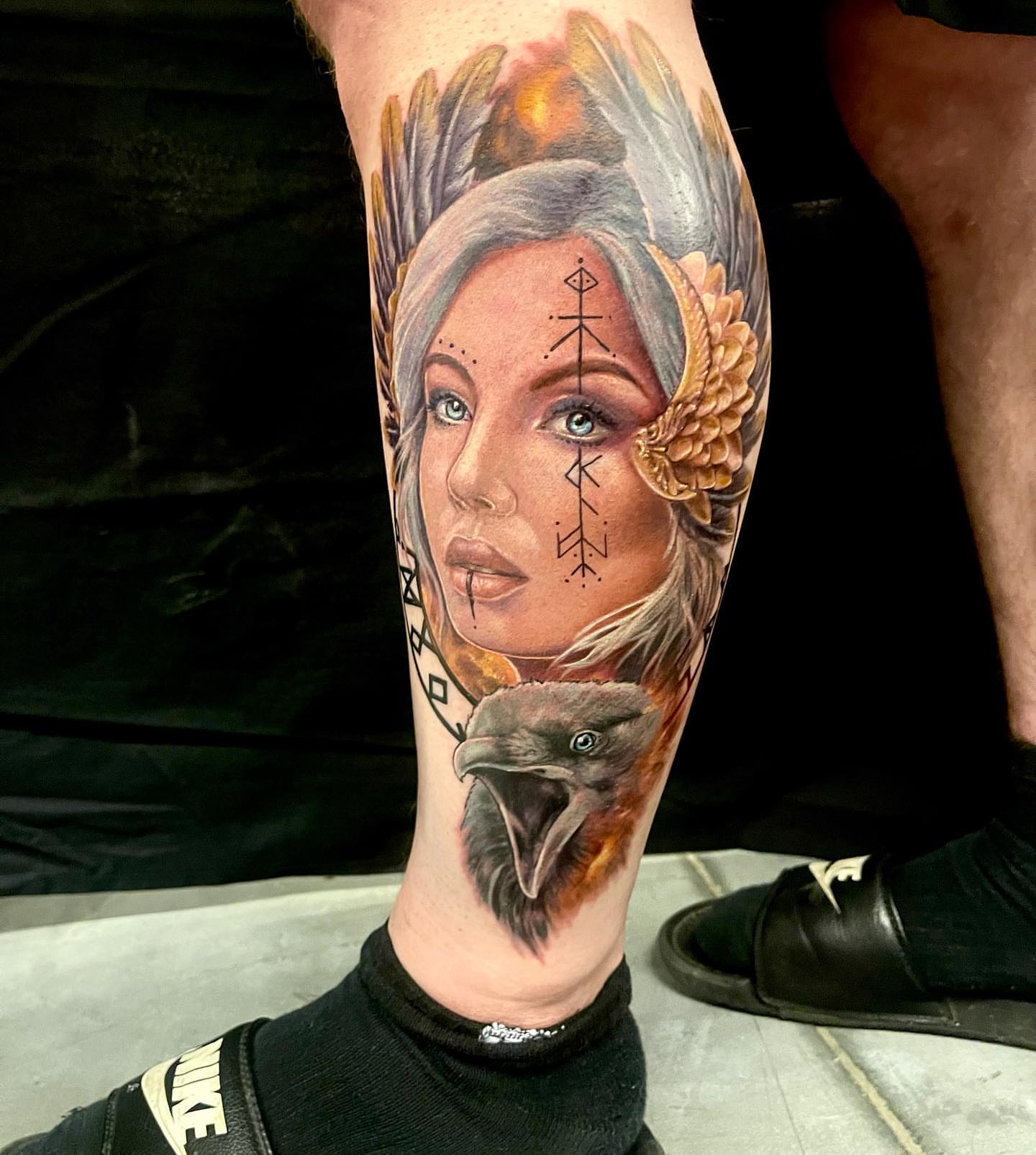 Woman with raven realism tattoo on the forearm by Amber Joy (AJ)