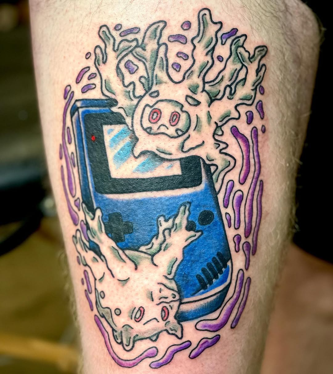 Game Boy with ghost characters new school tattoo on the forearm by Erin Stephens