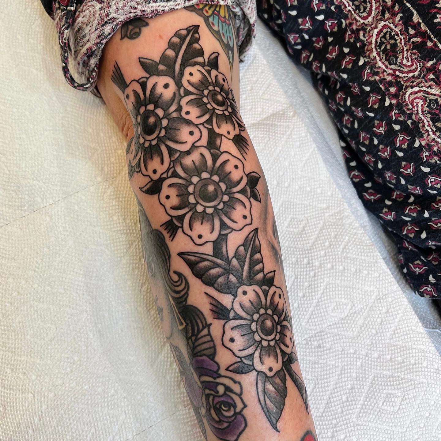 Floral bouquet American traditional tattoo on the forearm by David Mendieta