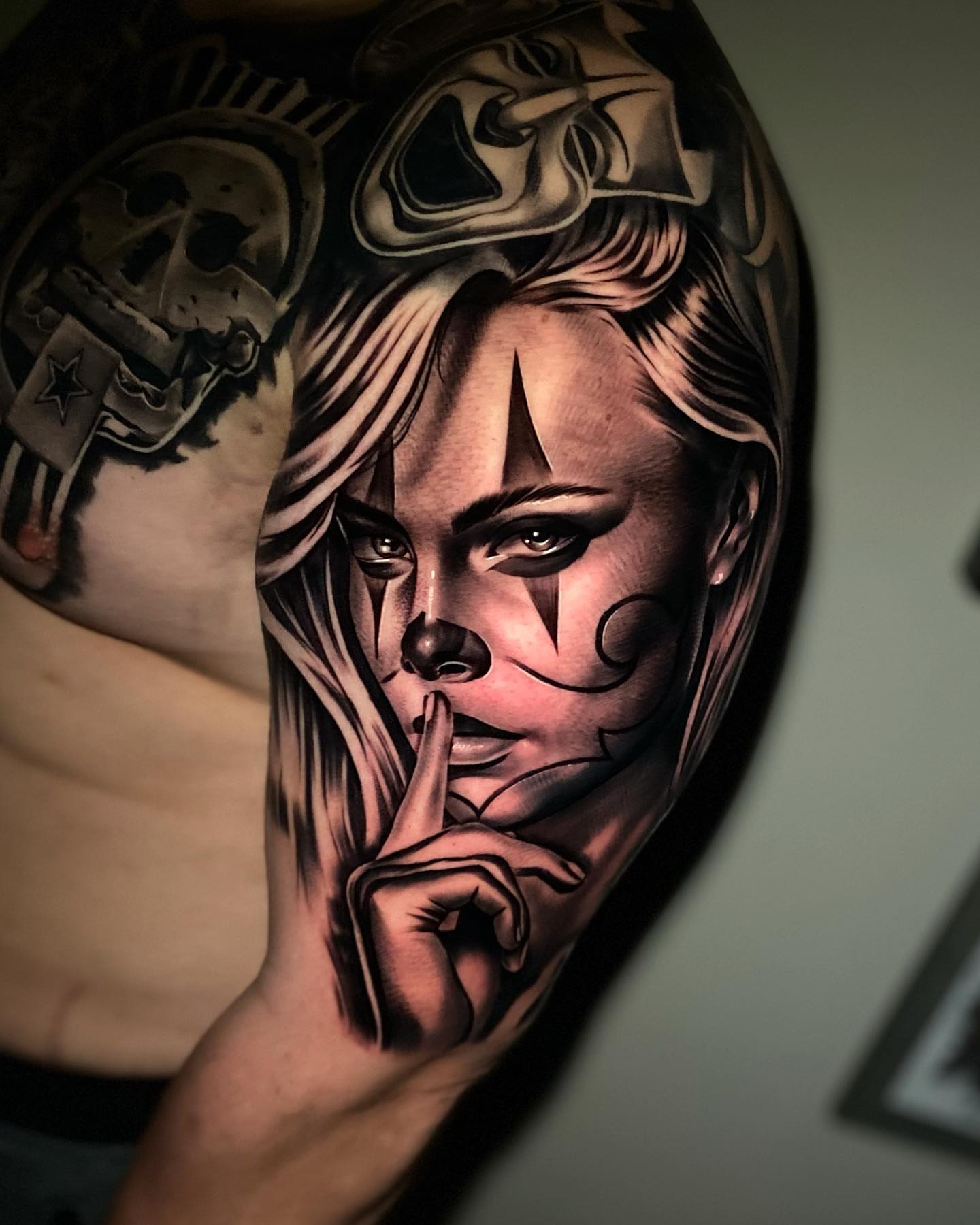 Woman with finger on lips realism tattoo on the shoulder by eksoe_