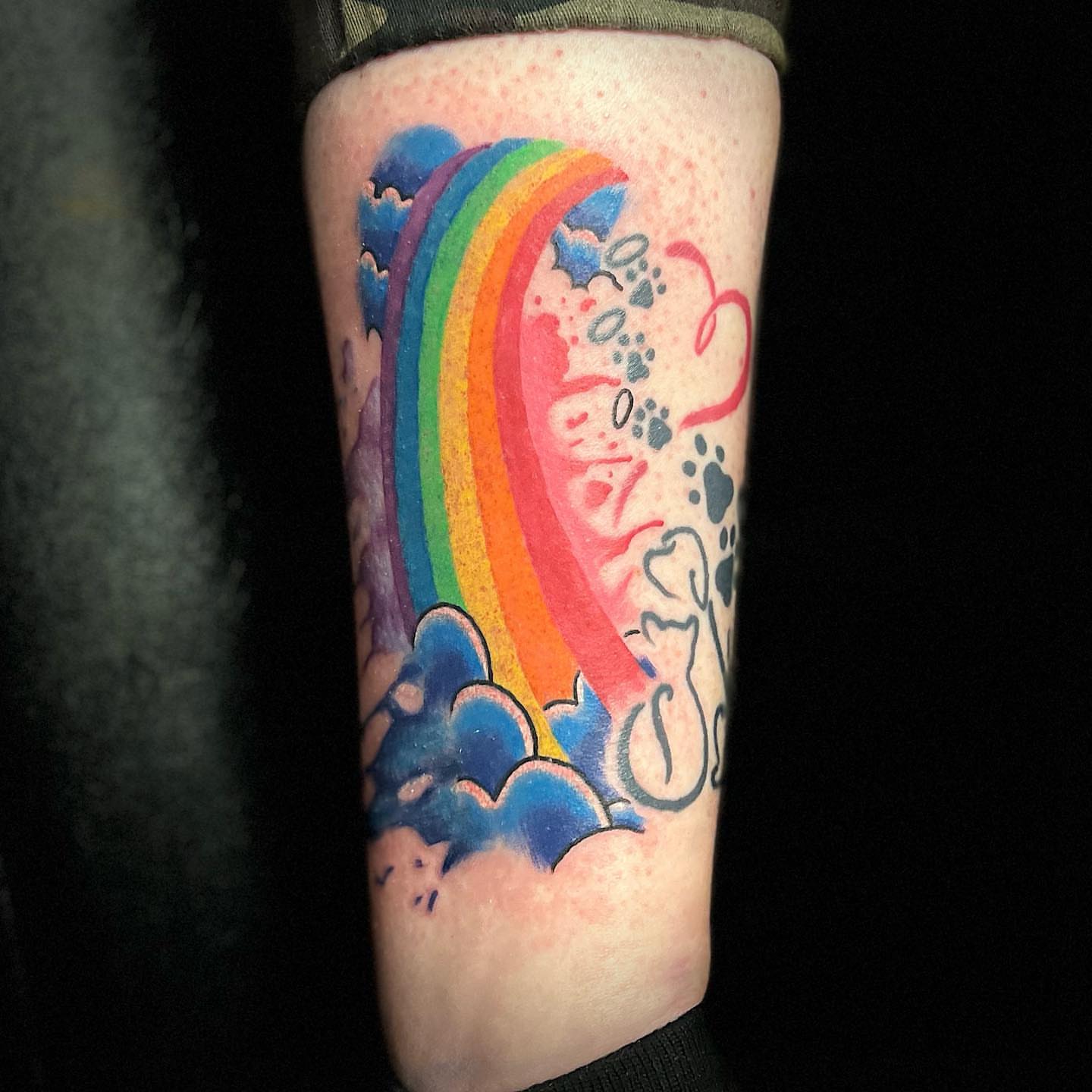 Rainbow and clouds new school tattoo on the forearm by Luis Cabrera, Cleveland, Ohio