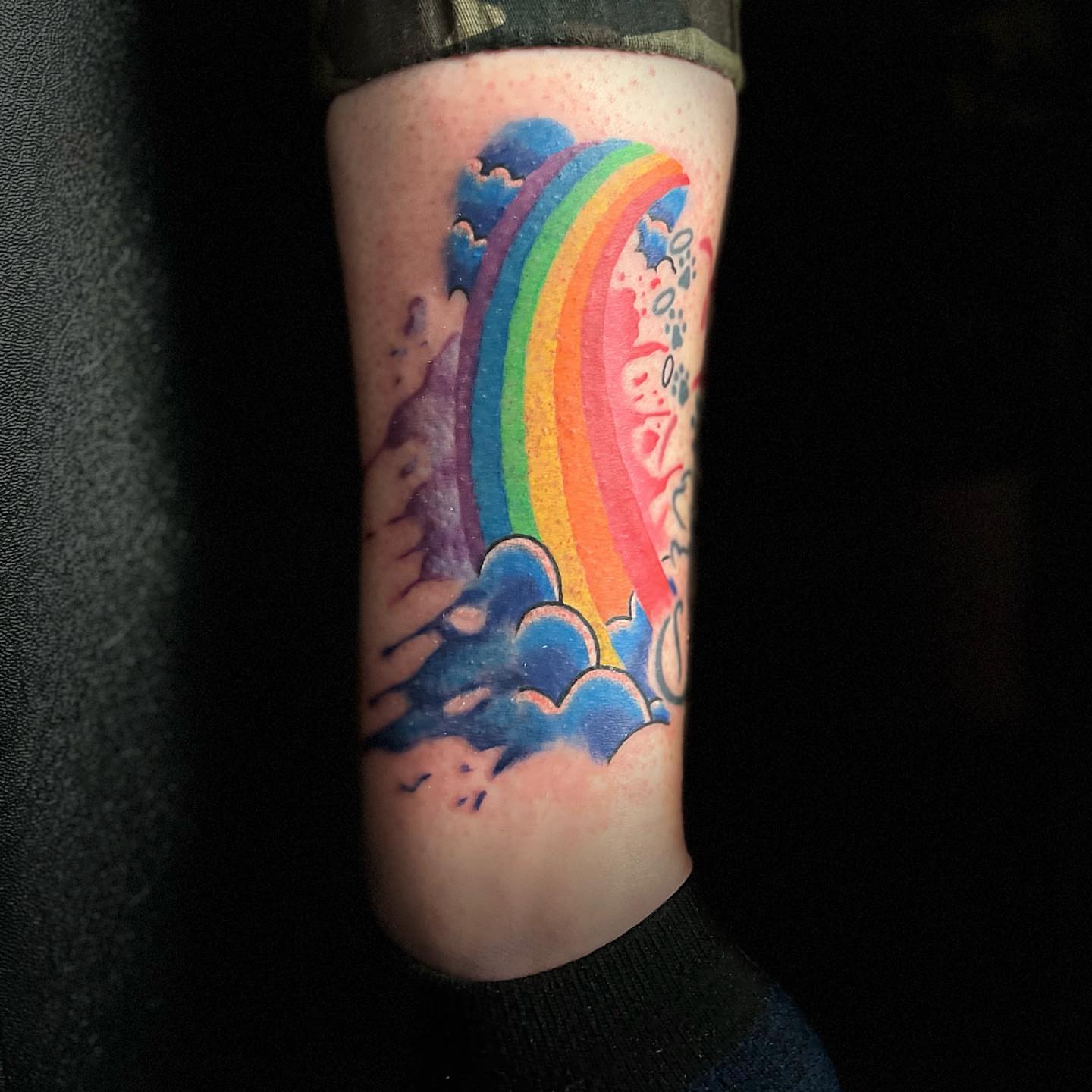 Rainbow and clouds new school tattoo on the forearm by Luis Cabrera, Cleveland, Ohio