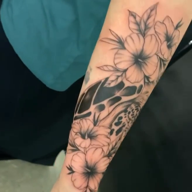 Sea turtle and flowers fine line tattoo by Moose