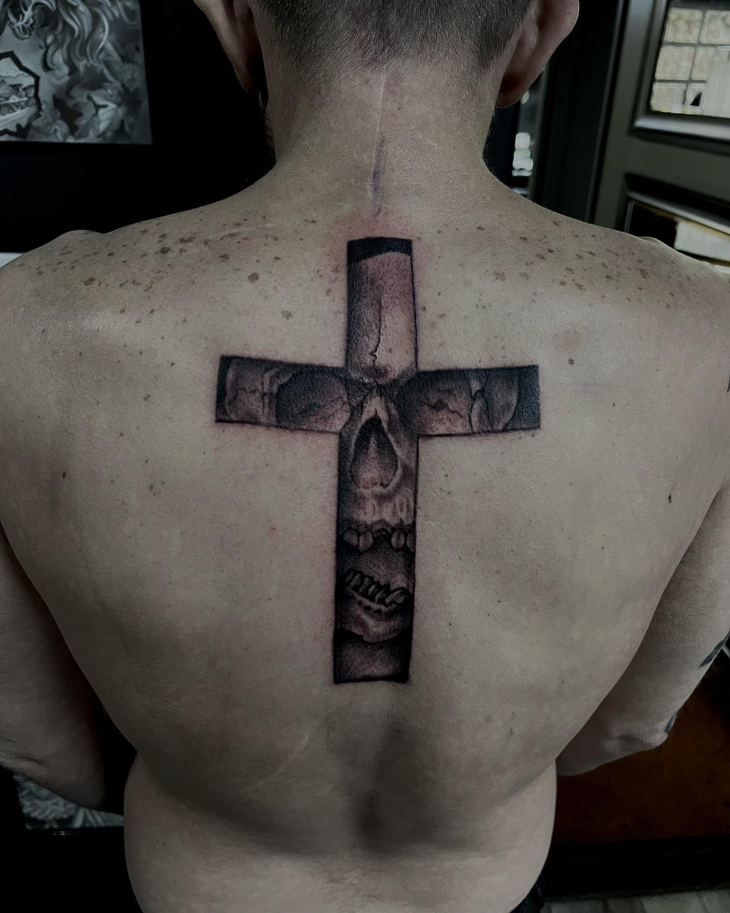 Cross with skull realism tattoo on the back by Tattoos by Dave