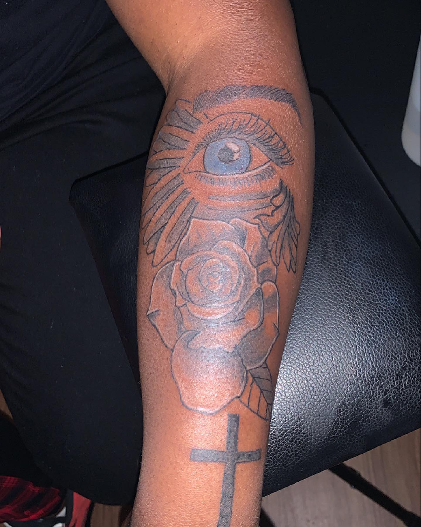 Eye and rose black and grey tattoo on the forearm by Evan Chastain