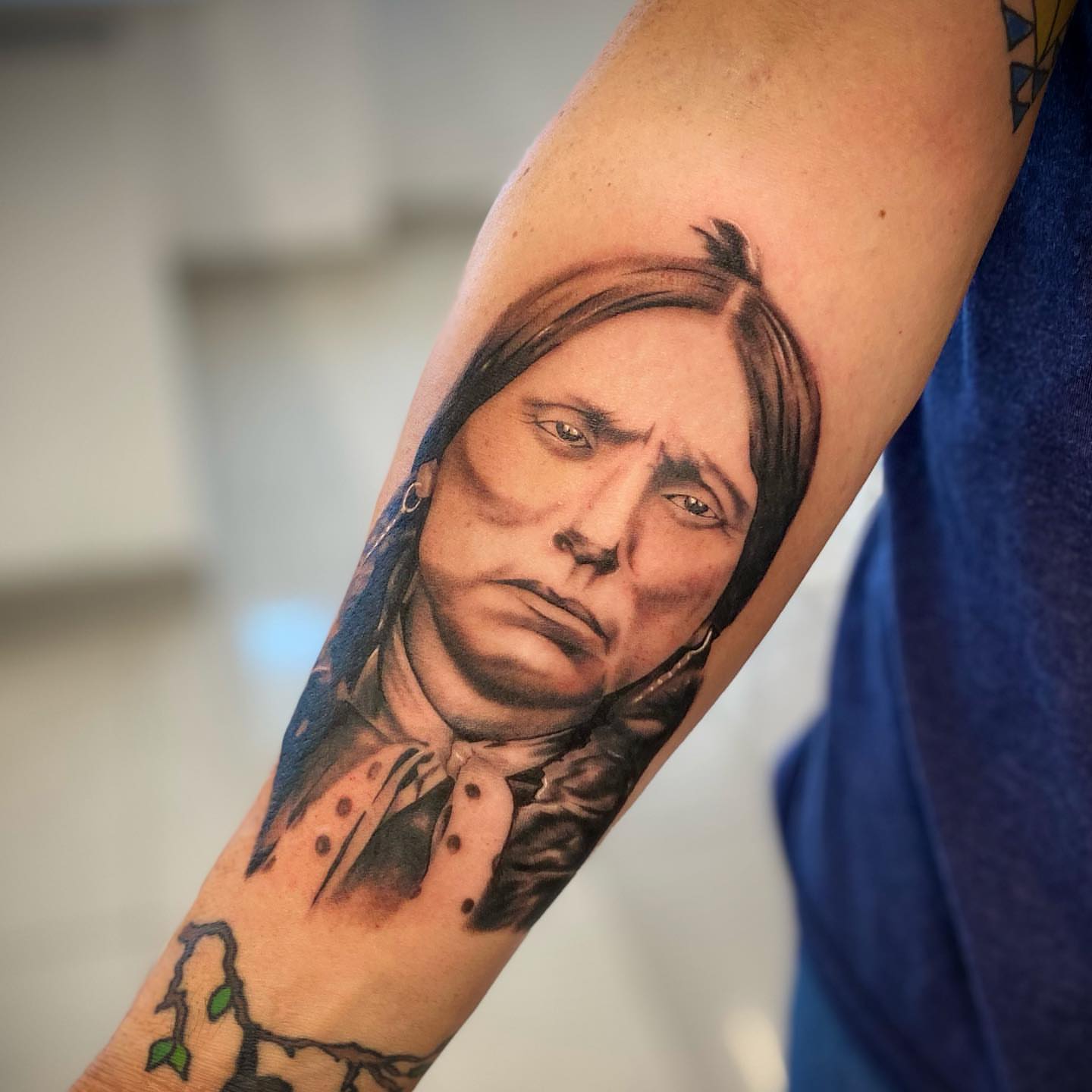 Portrait realism tattoo on the forearm by Christopher McGlone