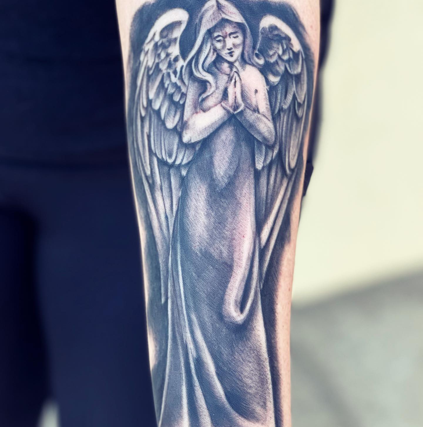 Angel black and grey tattoo on the forearm by Peewee Morales