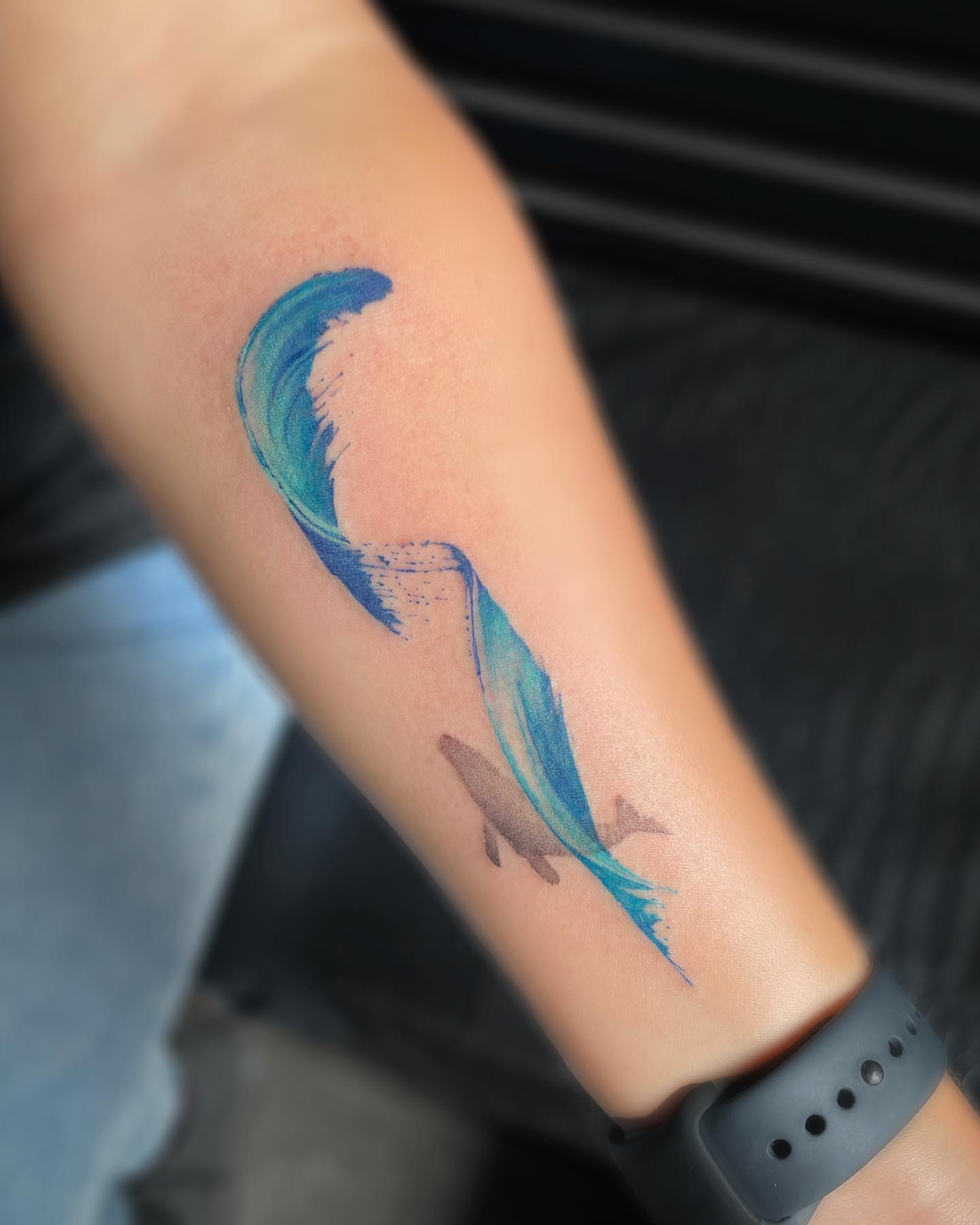 Wave and fish watercolor tattoo on the forearm by Georgia Grey