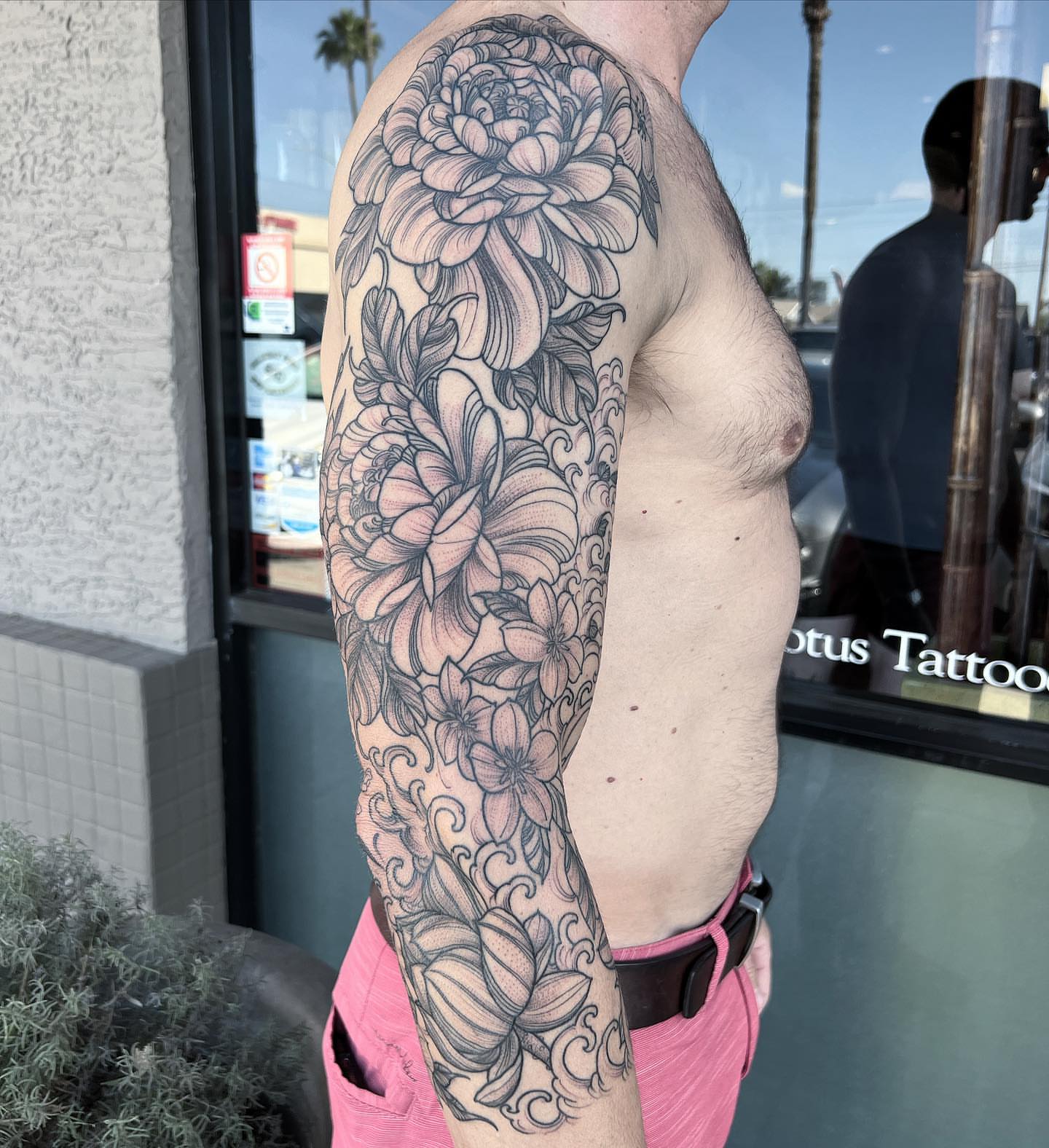 Floral bouquet black and grey tattoo on the upper arm by Byron Winkelman, Gilbert, Arizona