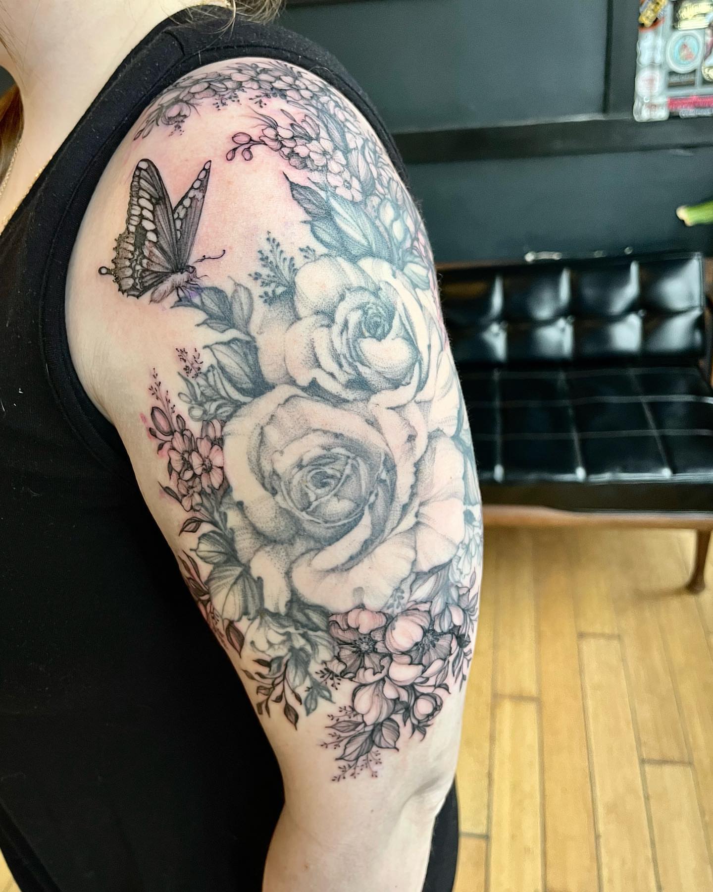 Flowers and butterfly realism tattoo on the shoulder by Sarah Spread