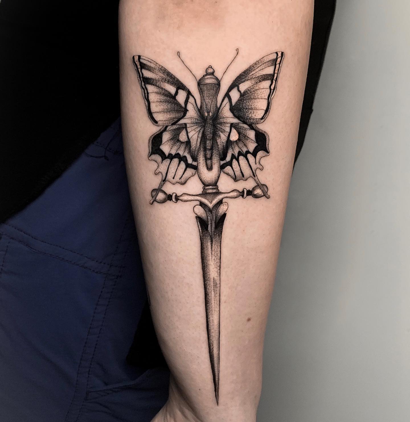 Butterfly and dagger dotwork tattoo on the forearm by Priscila, Los Angeles, California
