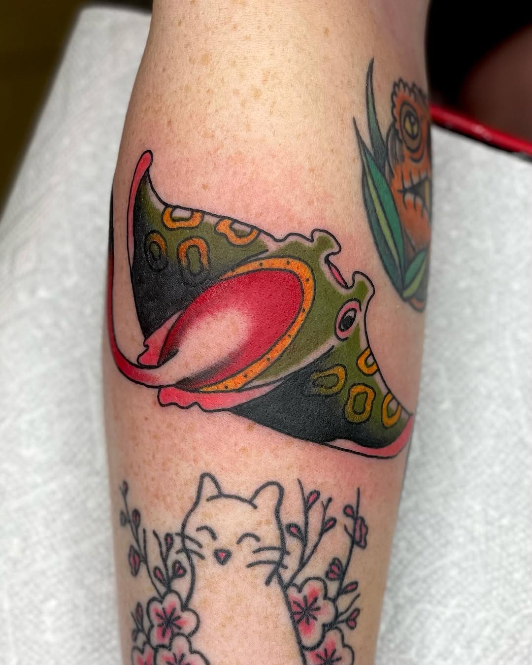 Manta ray and cat American traditional tattoo on the forearm by Erin Stephens