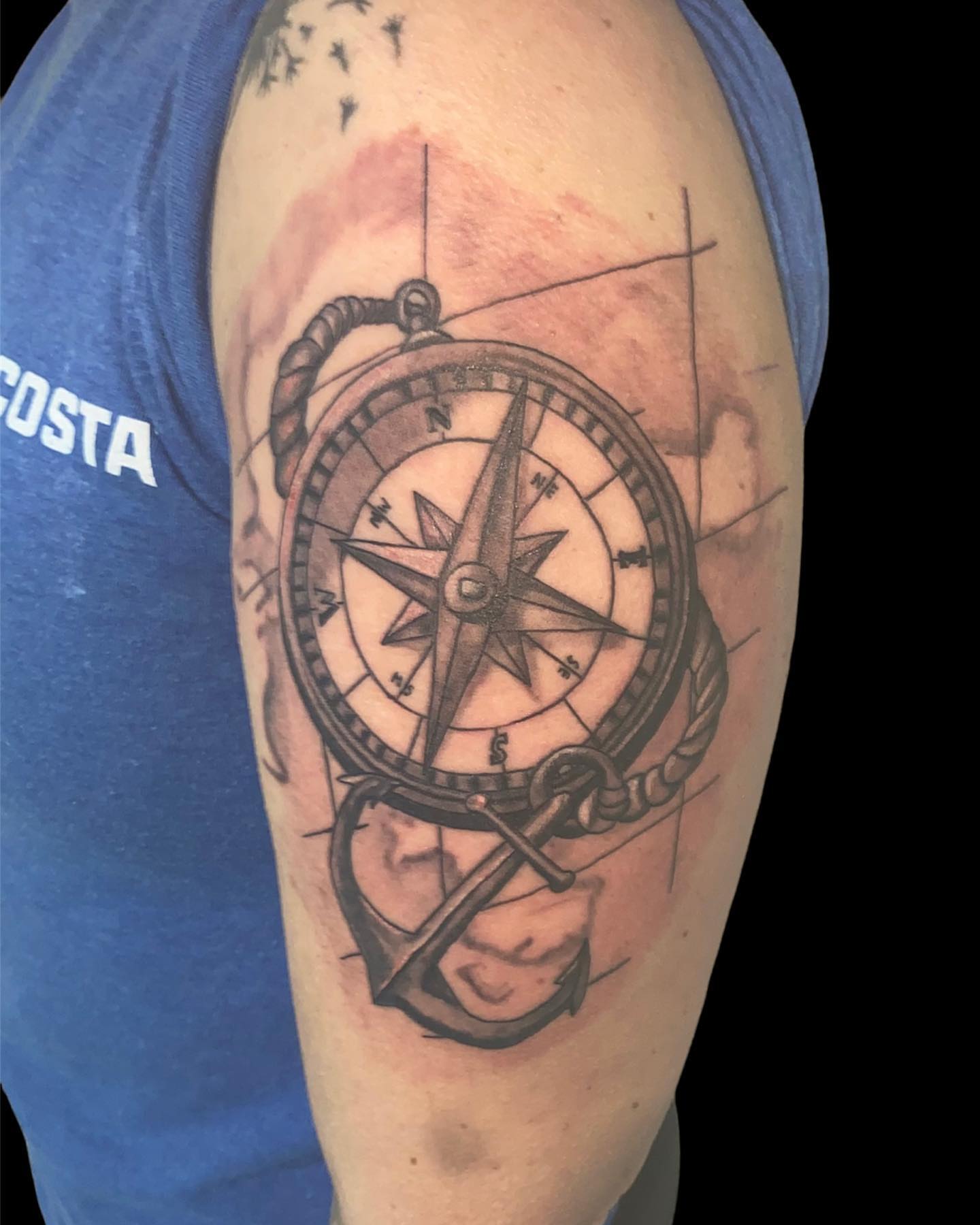 Compass and anchor black and grey tattoo on the forearm by Zach Ashton