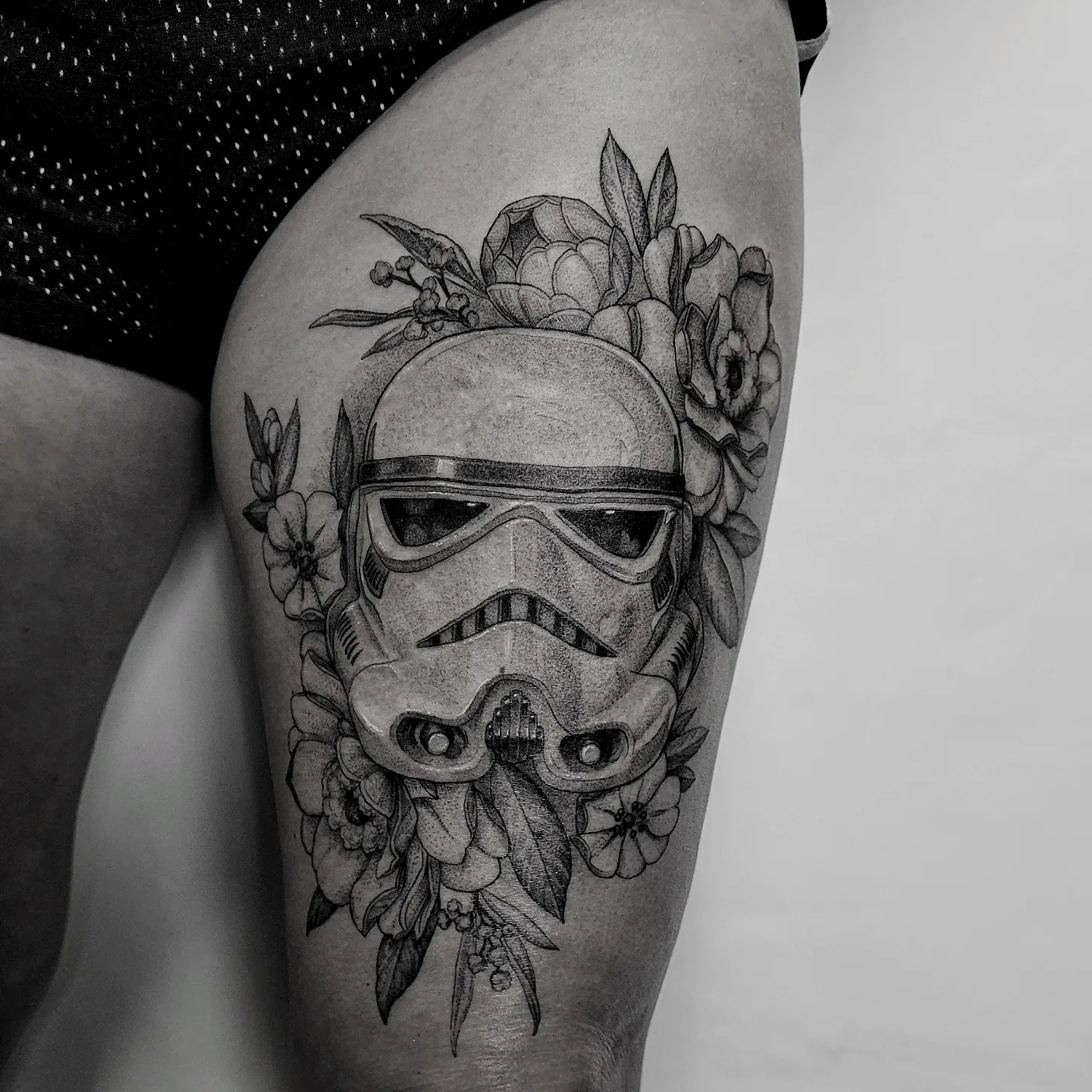 Stormtrooper helmet with floral elements realism tattoo on the thigh by Matthew Barnett