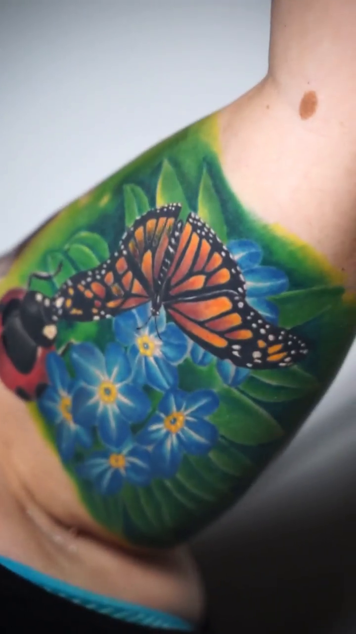 Butterfly and ladybug on flowers realism tattoo by Amaury Ramirez