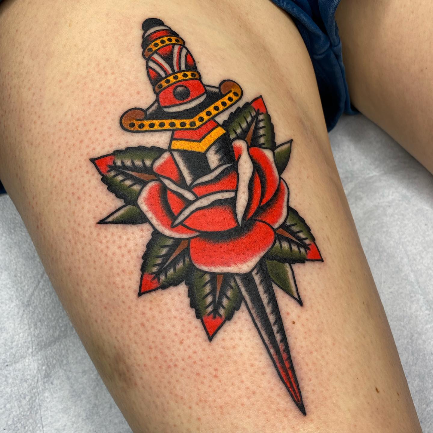 Rose and dagger American traditional tattoo on the thigh by andrewtattoos