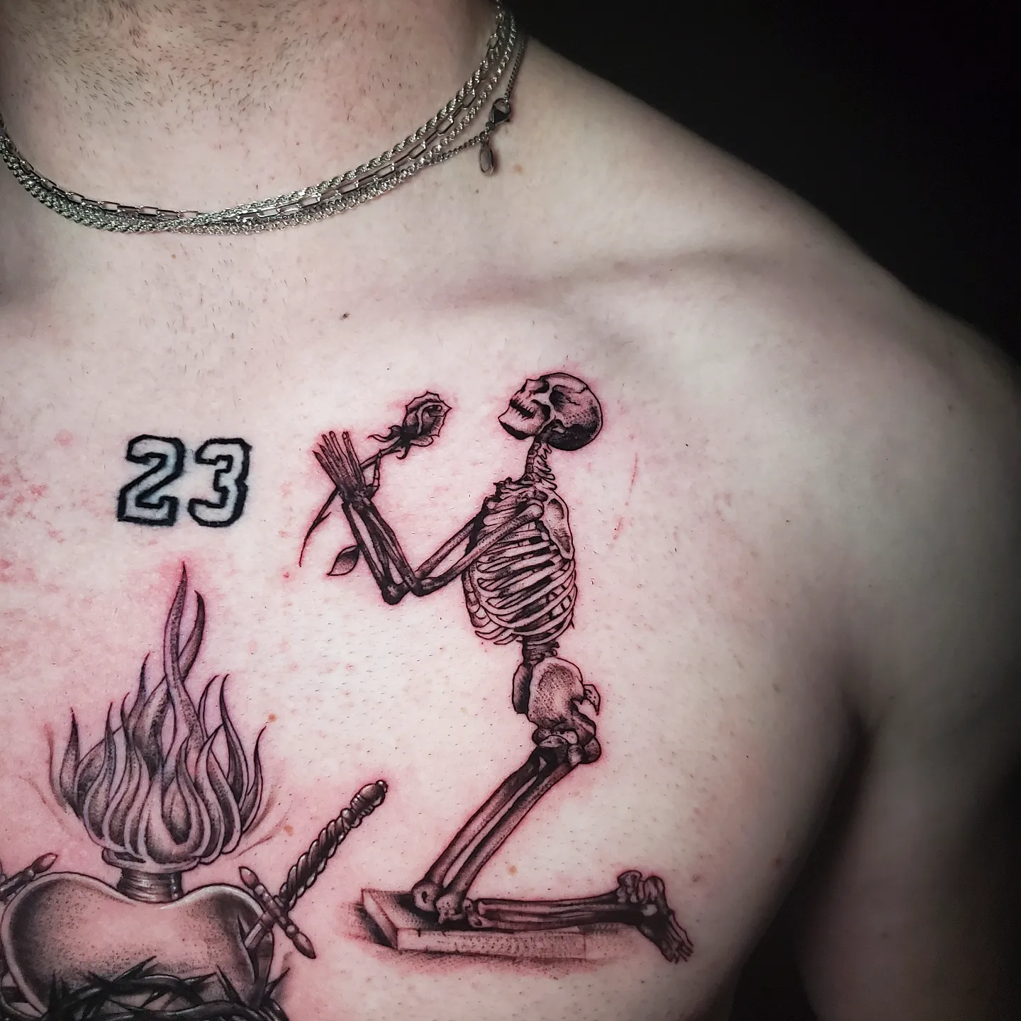 Skeleton with rose black and grey tattoo on the chest by Alex Suarez