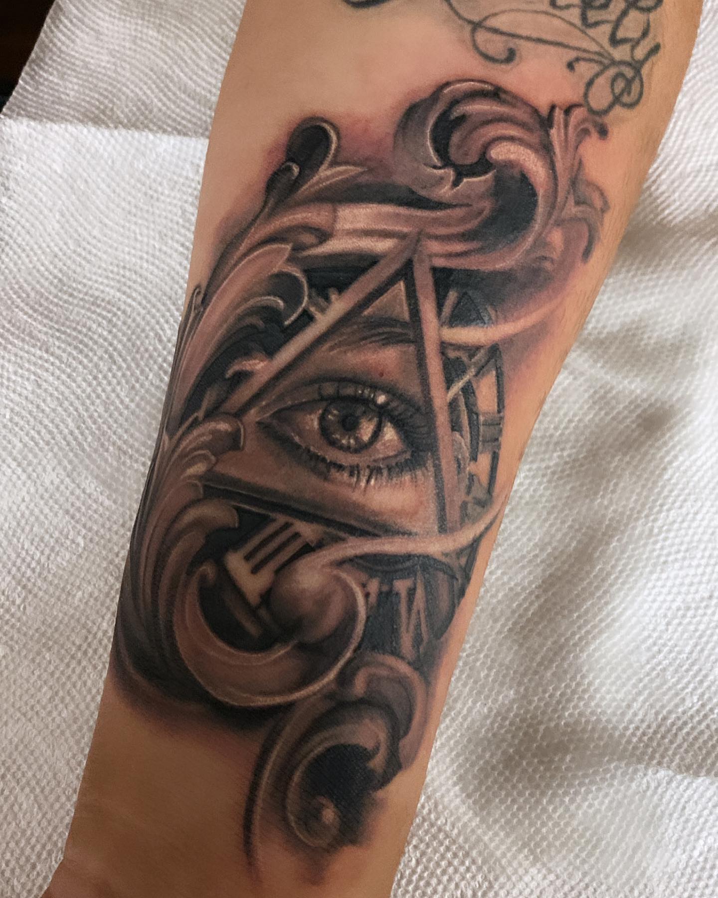 Eye and mechanical elements geometric tattoo on the forearm by ArteDeCecil