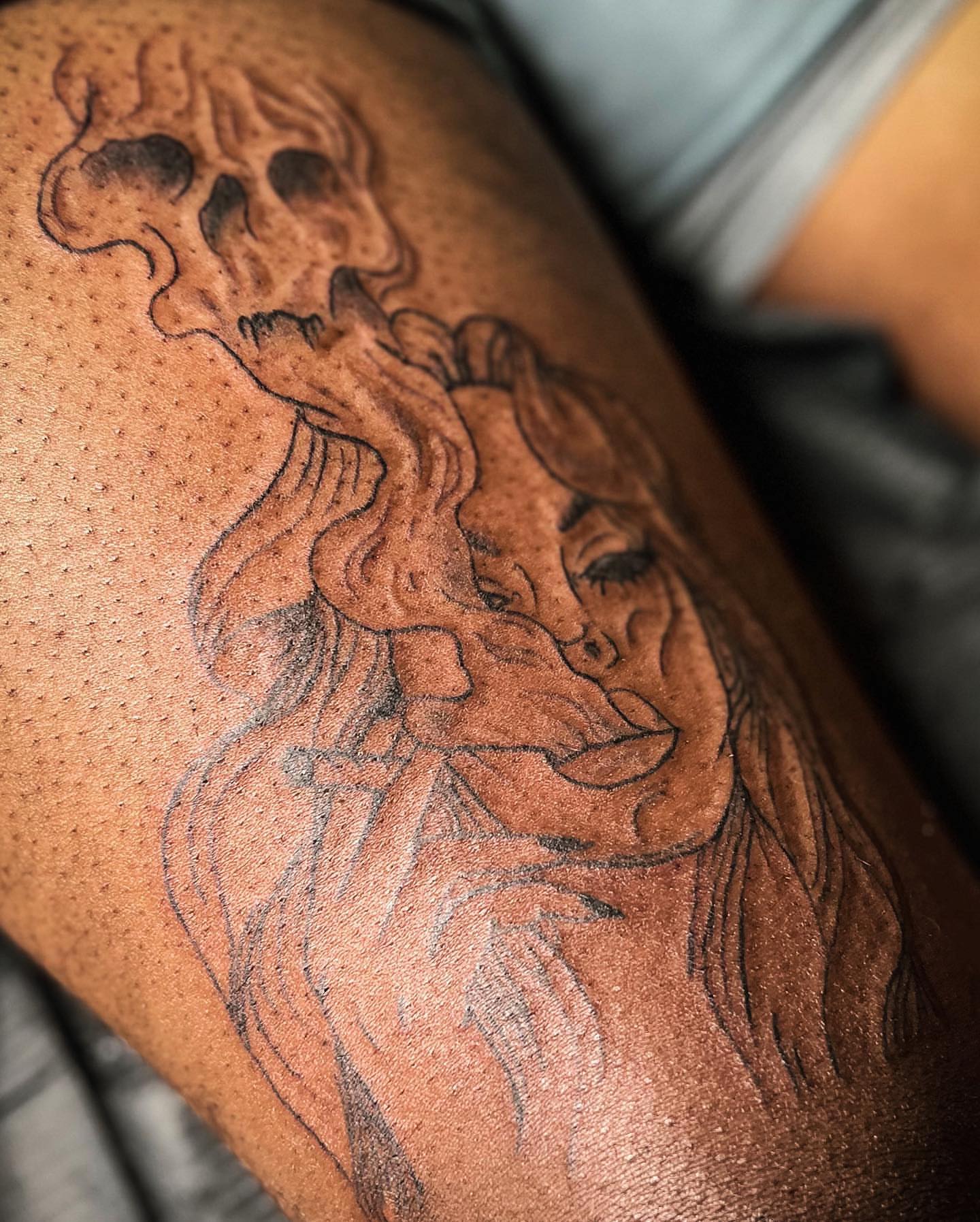 Woman with skull black and grey tattoo on the thigh by Traveling Tattoo Artist π