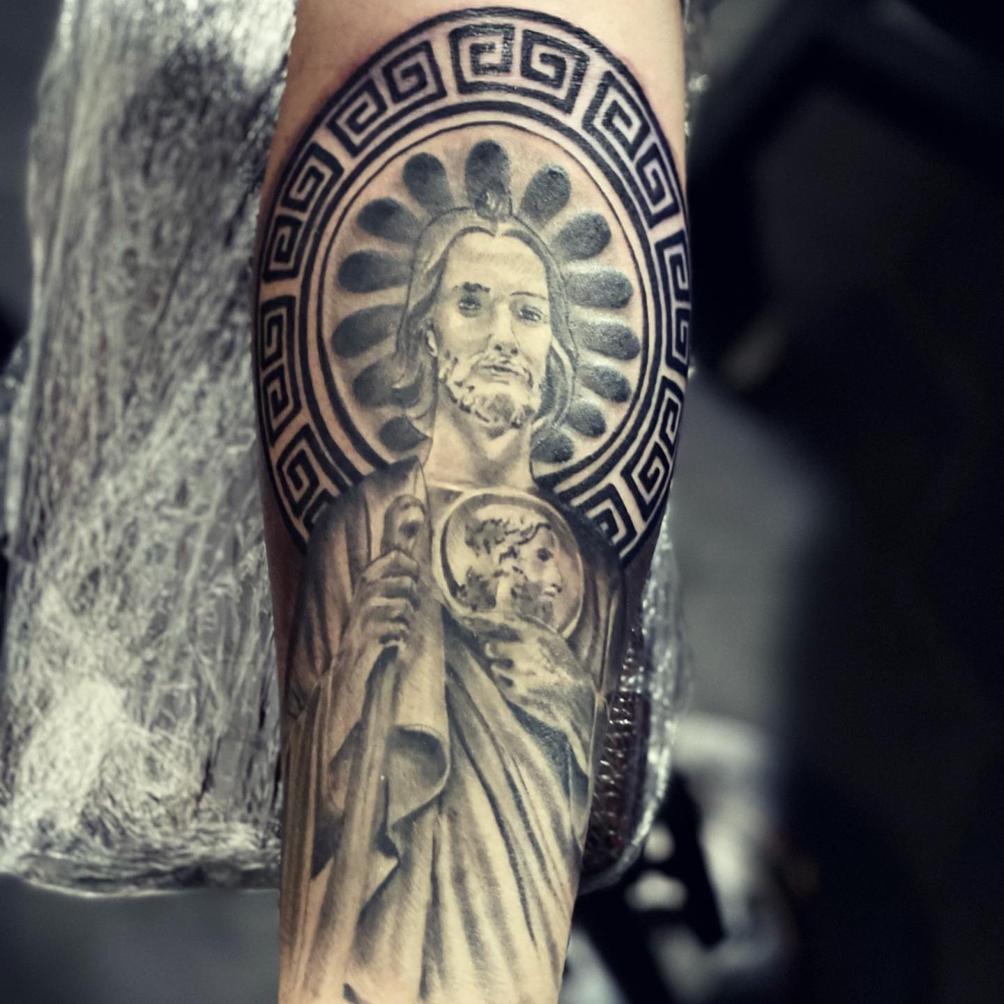Religious figure realism tattoo on the forearm by Peewee Morales