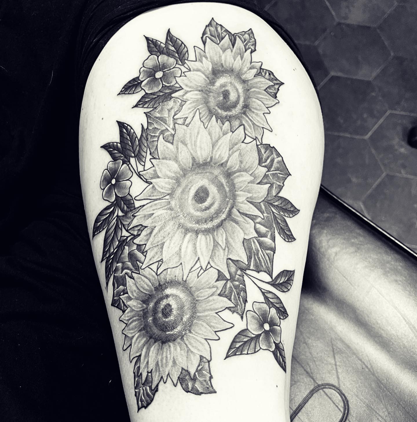 Sunflowers black and grey tattoo on the forearm by Peewee Morales
