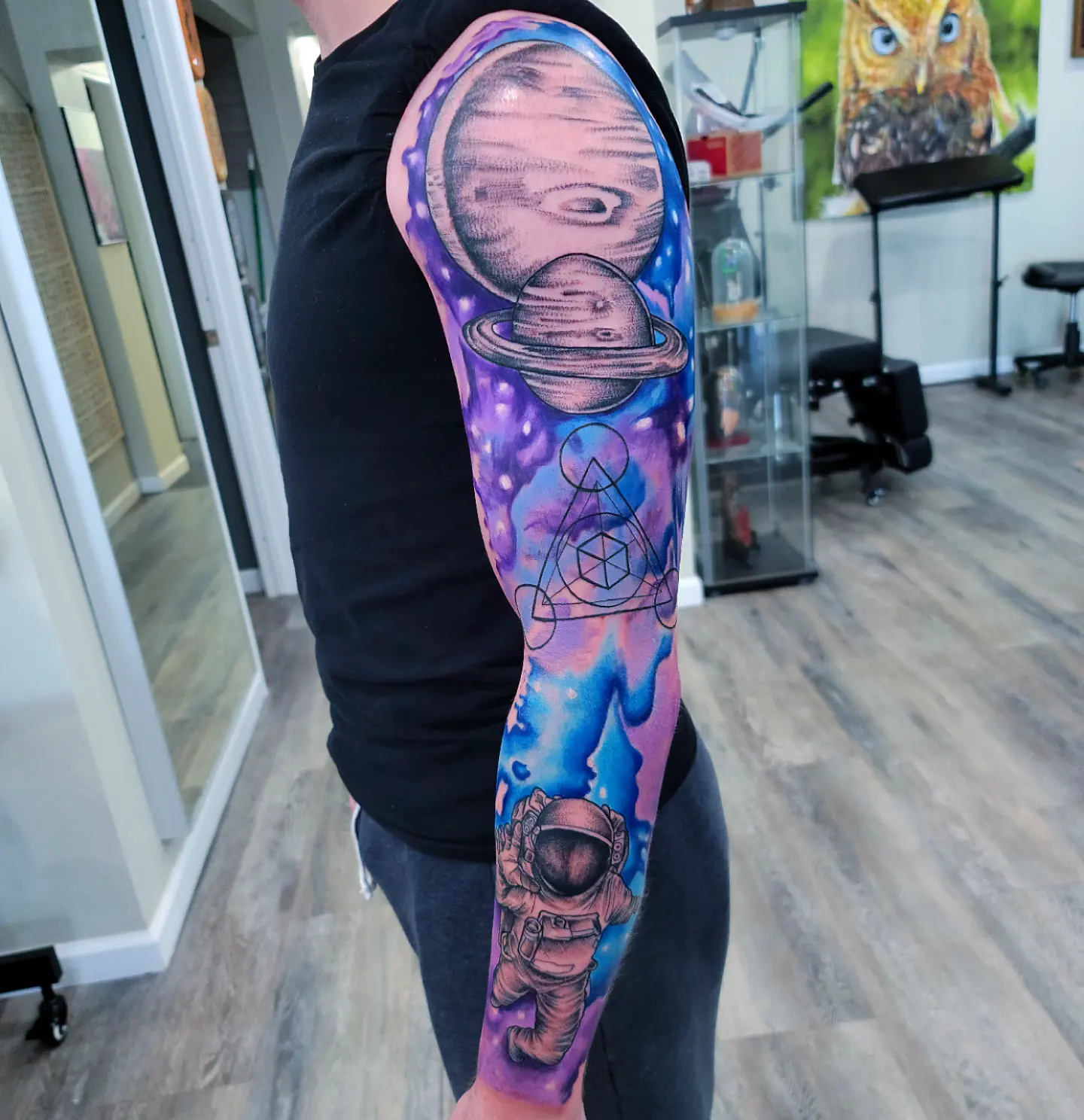 Space-themed tattoo realism tattoo on the forearm by Dick Eckman