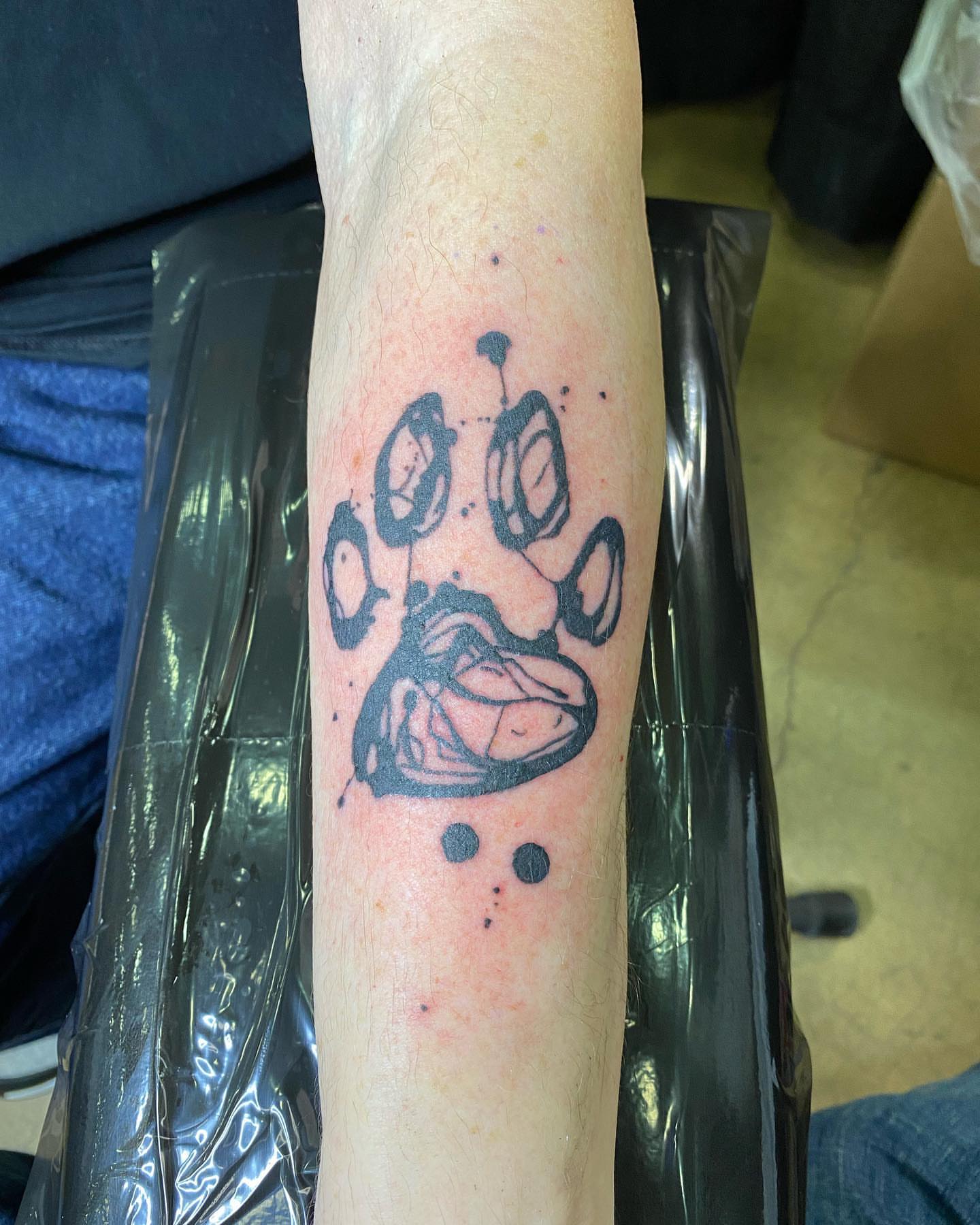 Paw print dotwork tattoo on the forearm by Keith Cromie