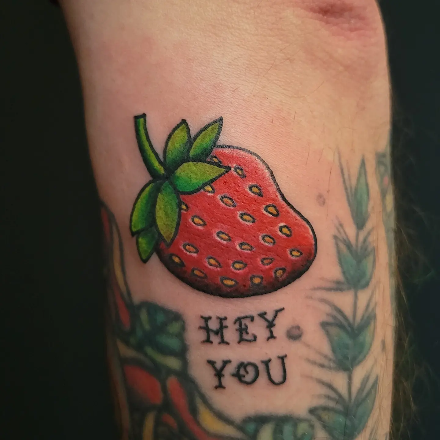 Strawberry dotwork tattoo on the forearm by Nicole Bett