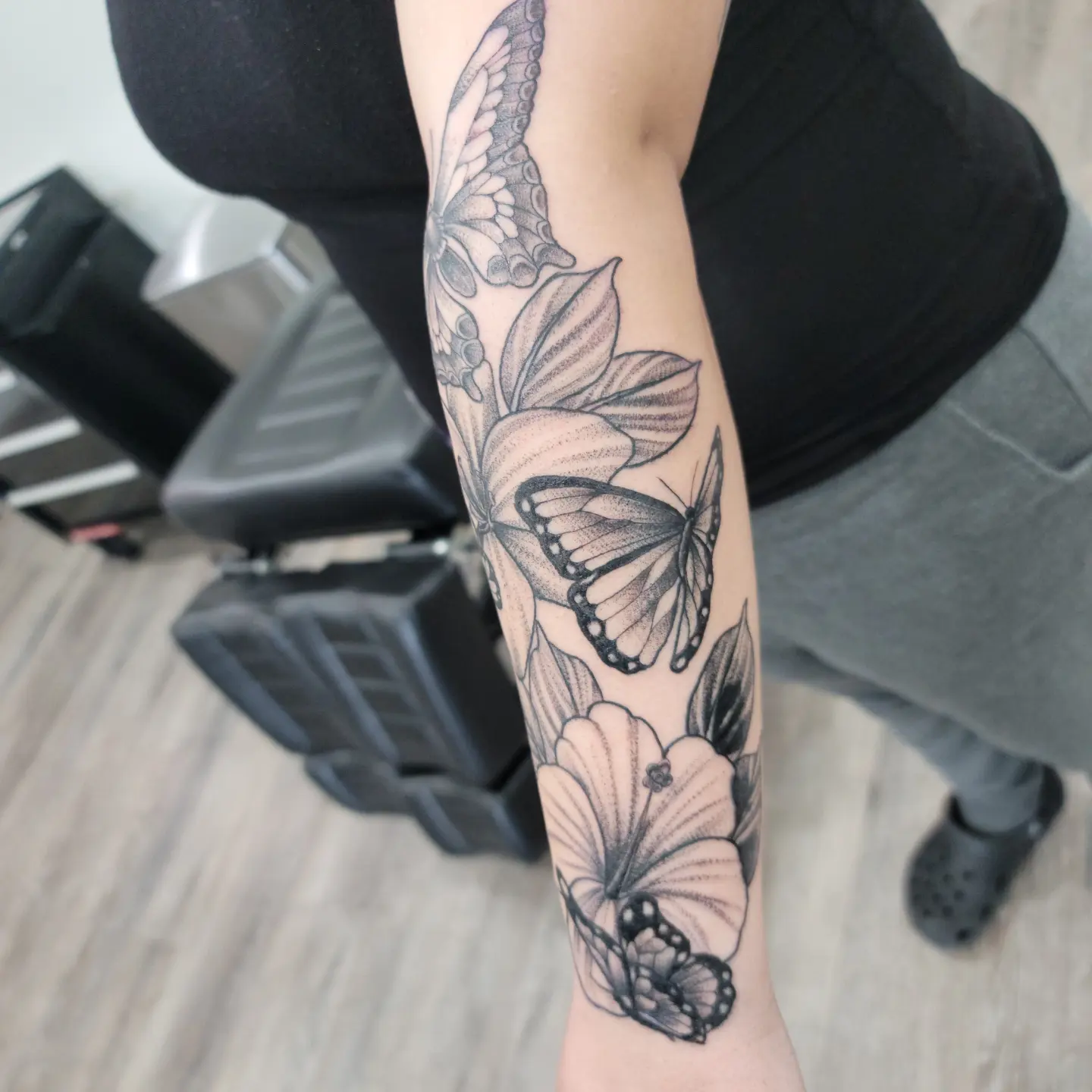 Butterflies and flowers dotwork tattoo on the forearm by Dick Eckman