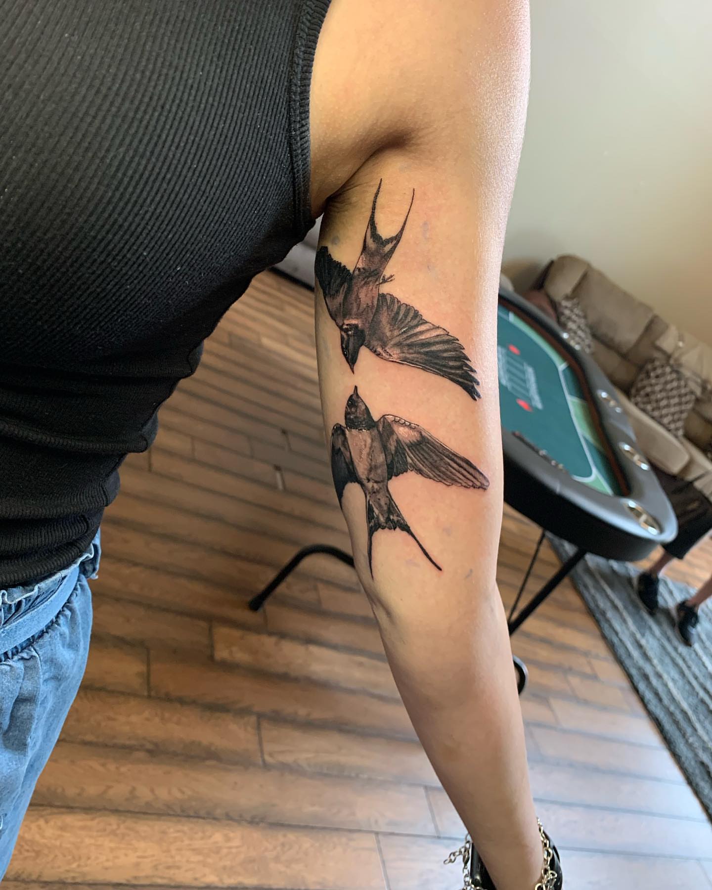 Swallows realism tattoo on the forearm by Leo Torres