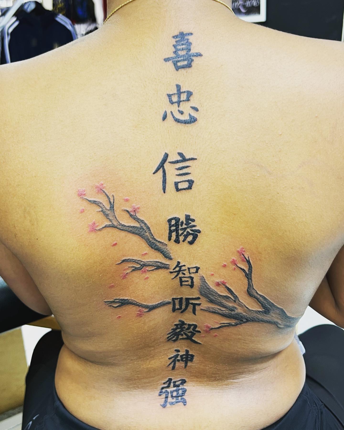 Cherry blossom branches with Chinese characters dotwork tattoo on the back by oxideTattoo, Morne-à-l'Eau