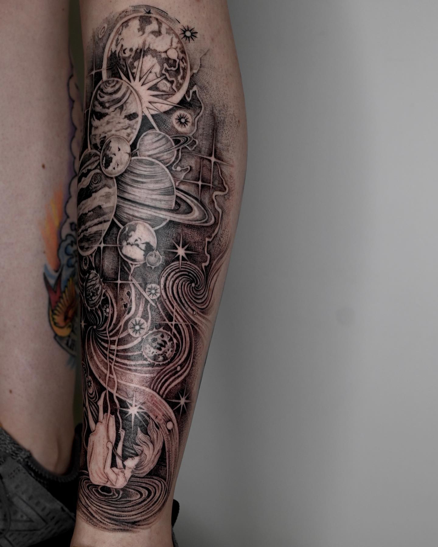 Space and celestial bodies realism tattoo on the forearm by Zay - Realistic tattoo Artist