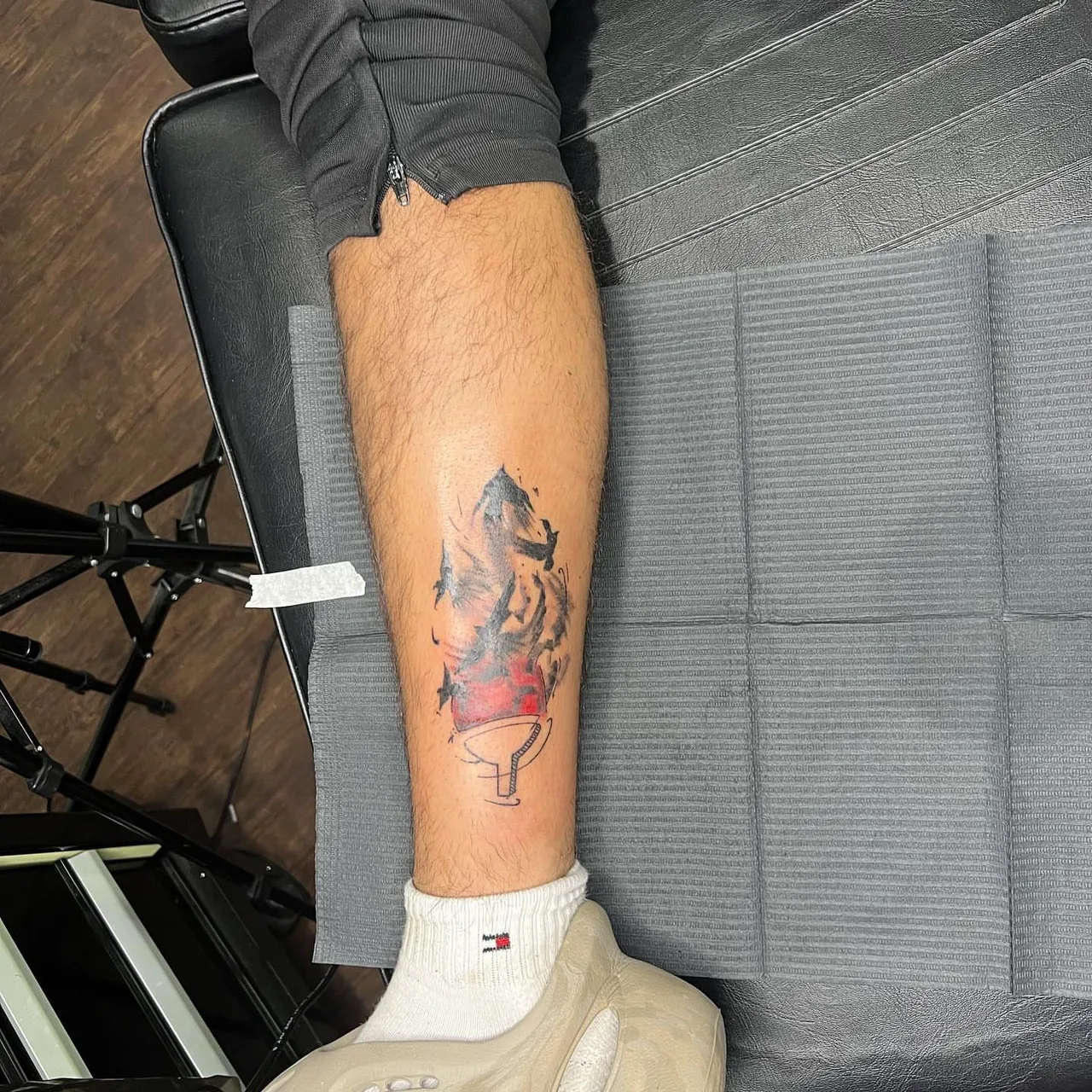 Abstract flame watercolor tattoo on the calf by Amilia Gullotta