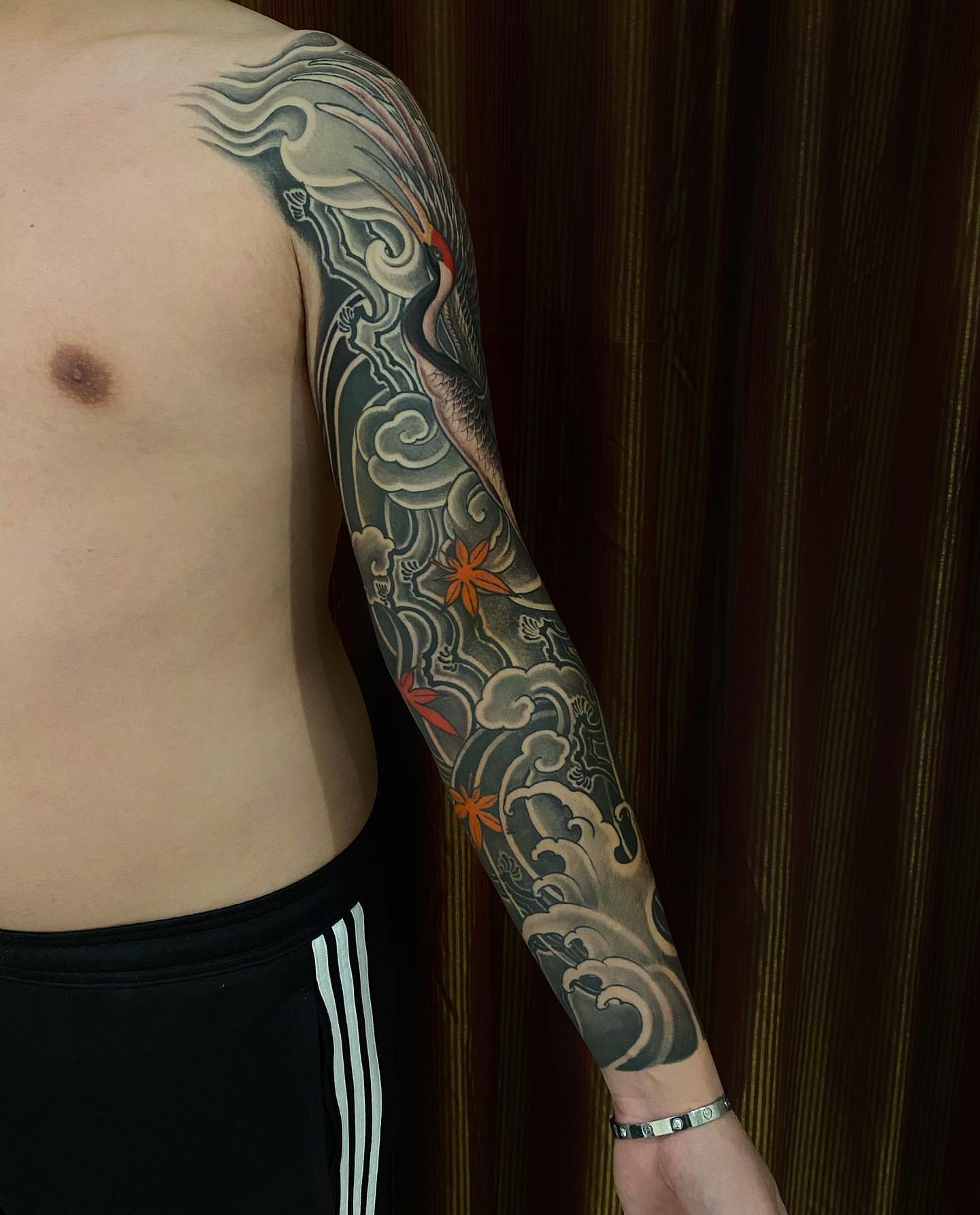 Crane and flowers japanese irezumi tattoo on the upper arm by H O R I H A N