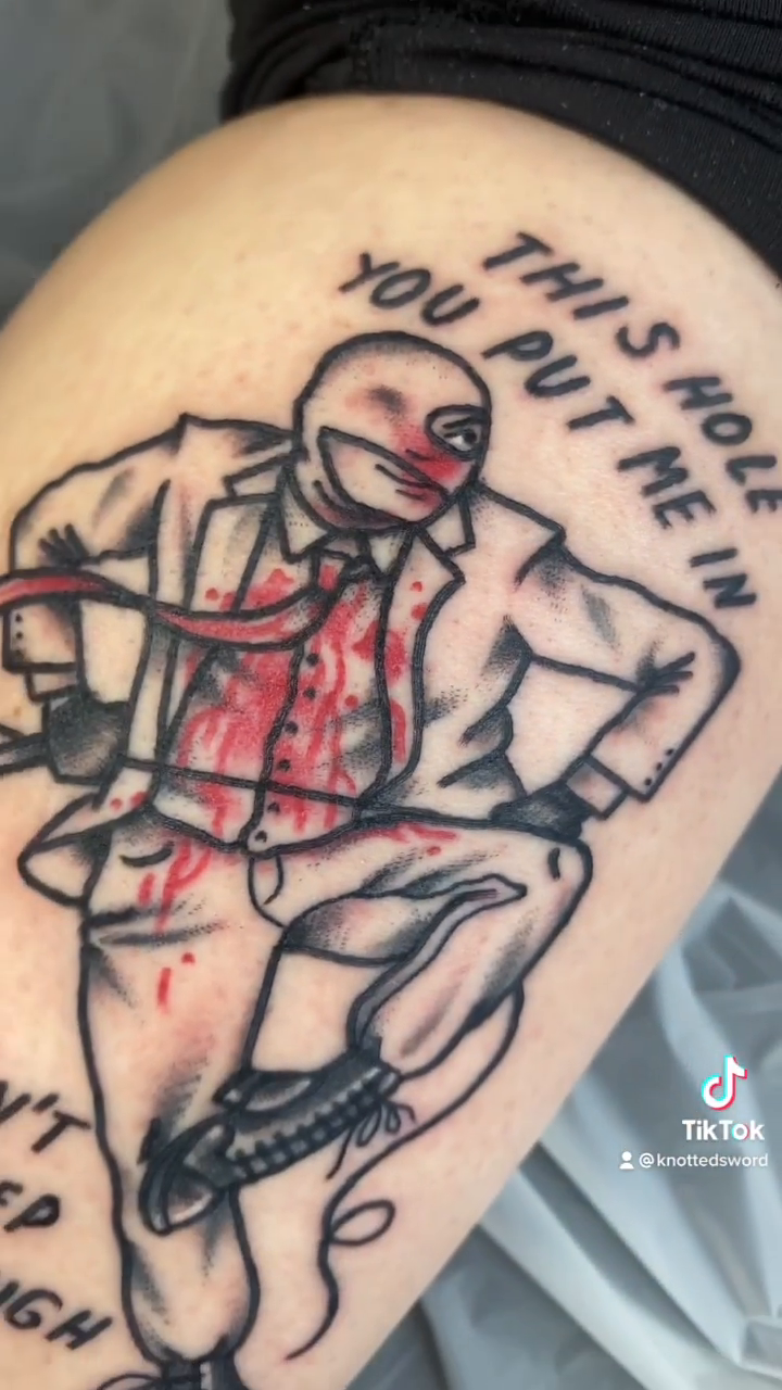 Man in suit with blood splatter ignorant tattoo on the leg by ππππππππ