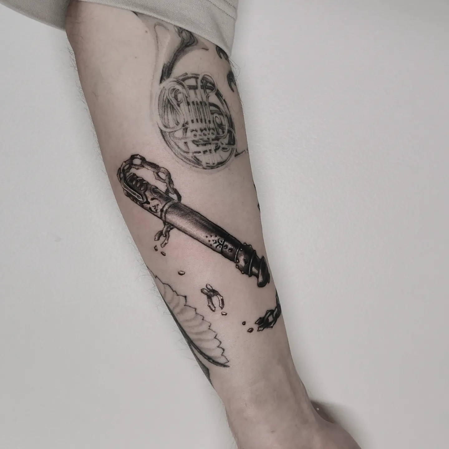 Broken key black and grey tattoo on the forearm by Lindsay