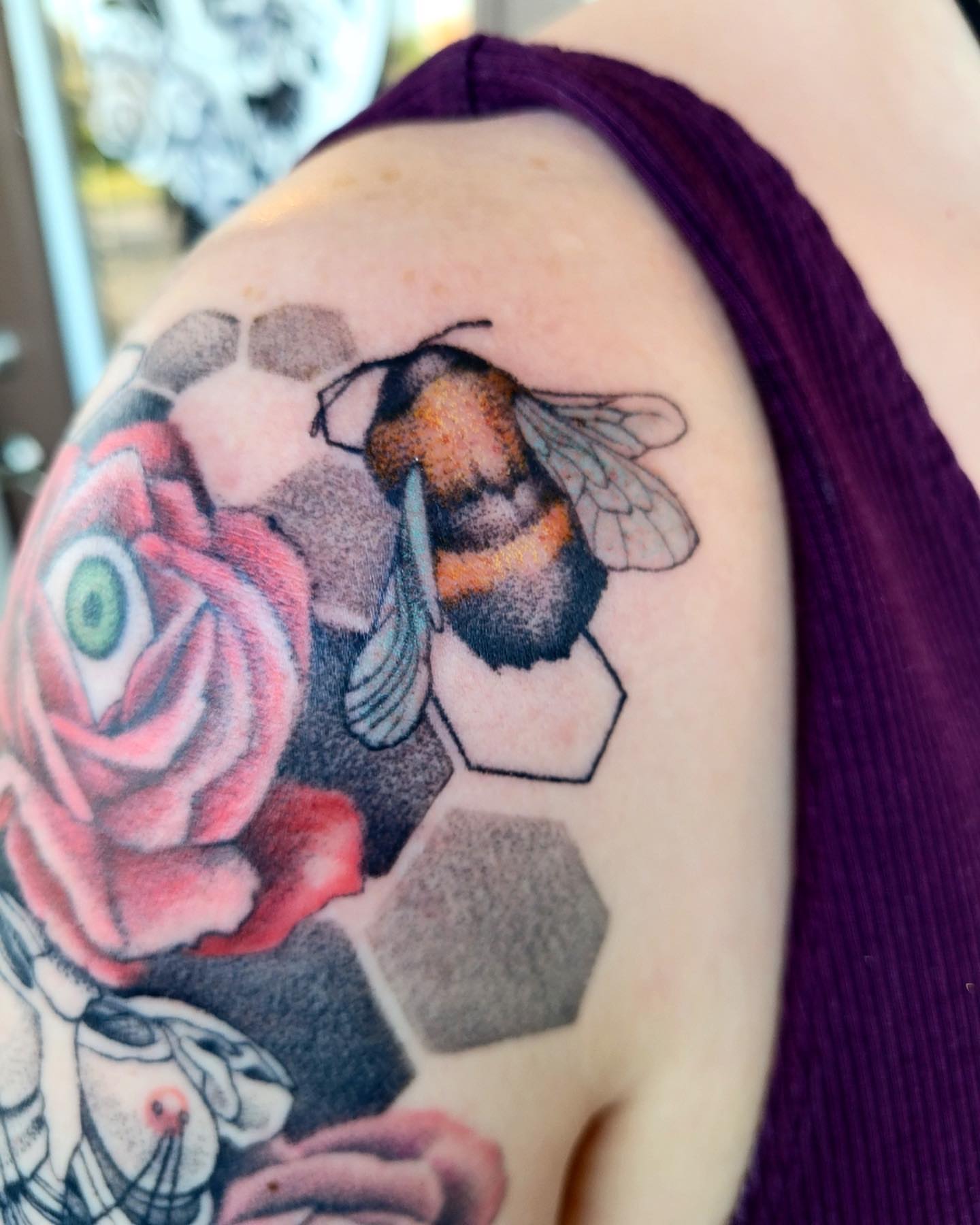 Bee and rose realism tattoo on the shoulder by Emily Jestine Francis