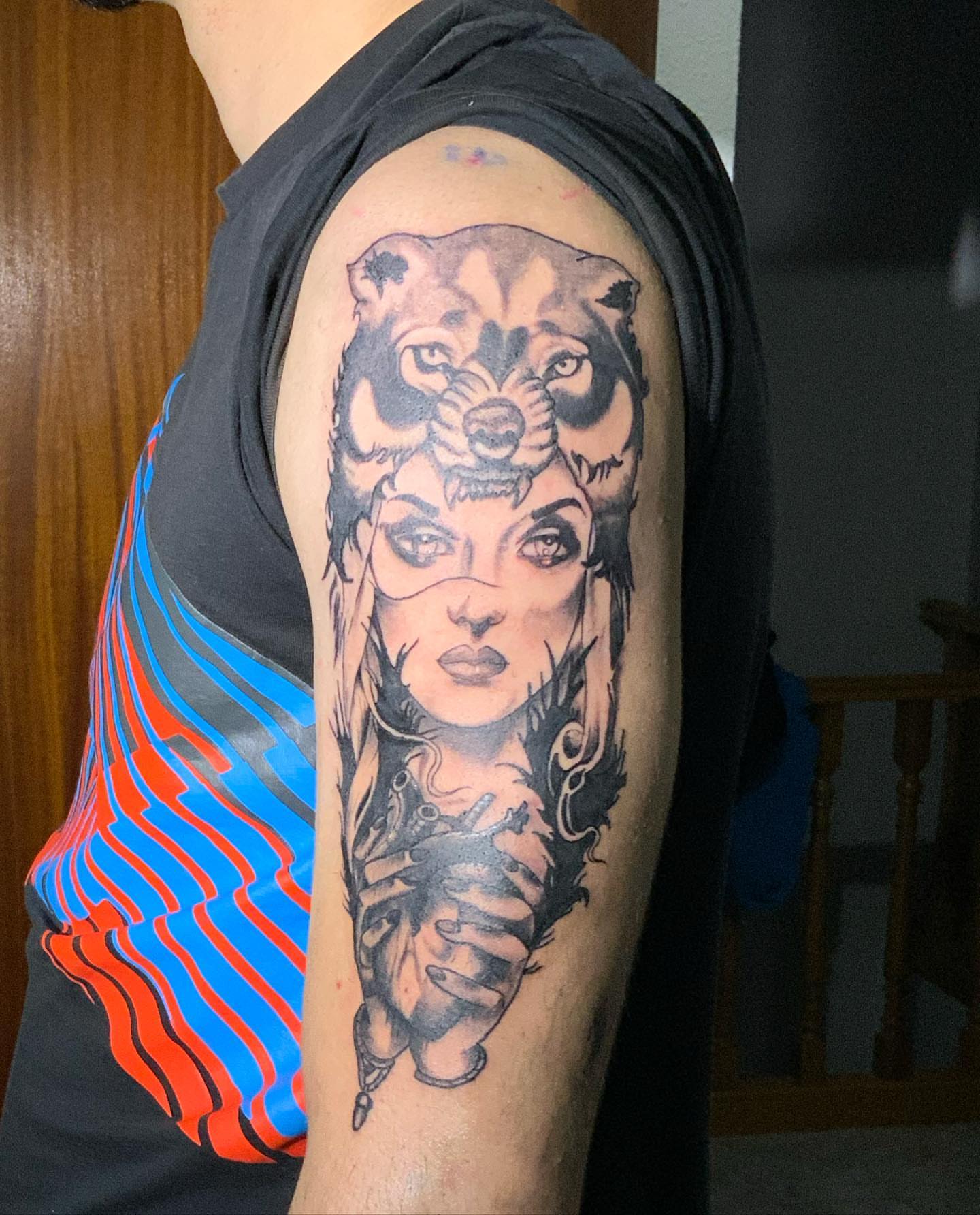 Woman with animal head realism tattoo on the upper arm by Kunaytattoo