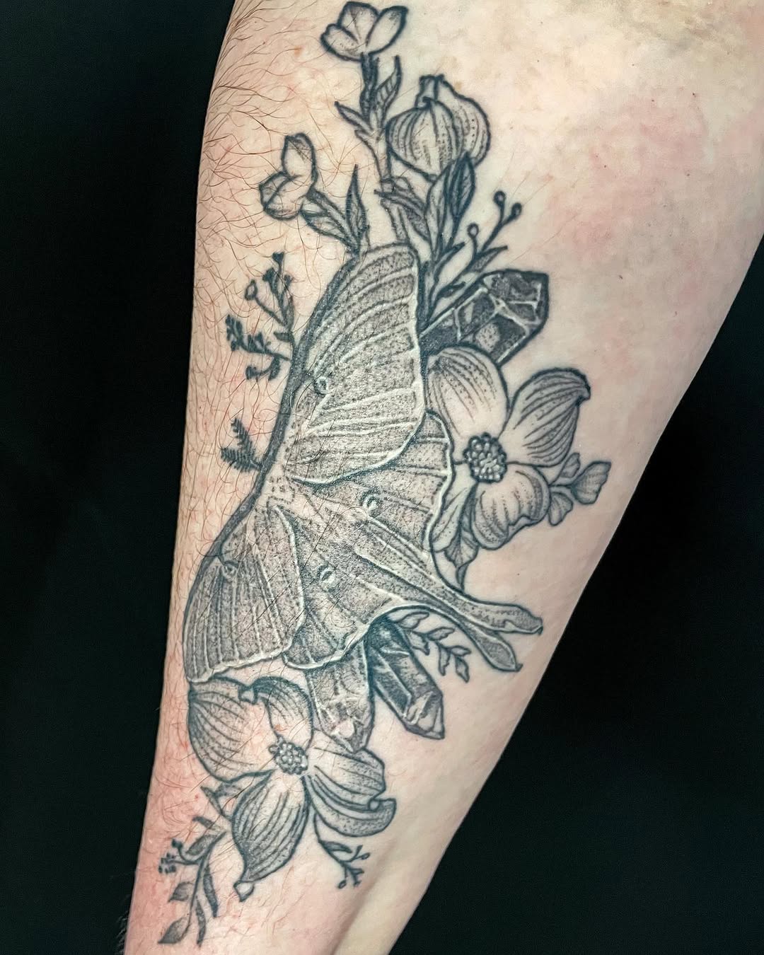 Luna moth with flowers and crystals fine line tattoo on the forearm by Thylacine Tattoo & Art, Los Angeles, California