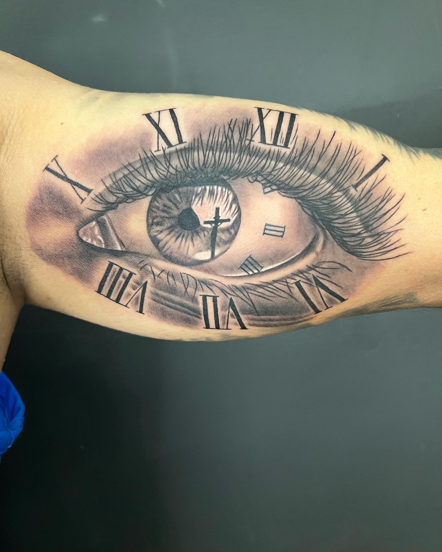 Eye with clock realism tattoo on the forearm by CHiNO iNKs