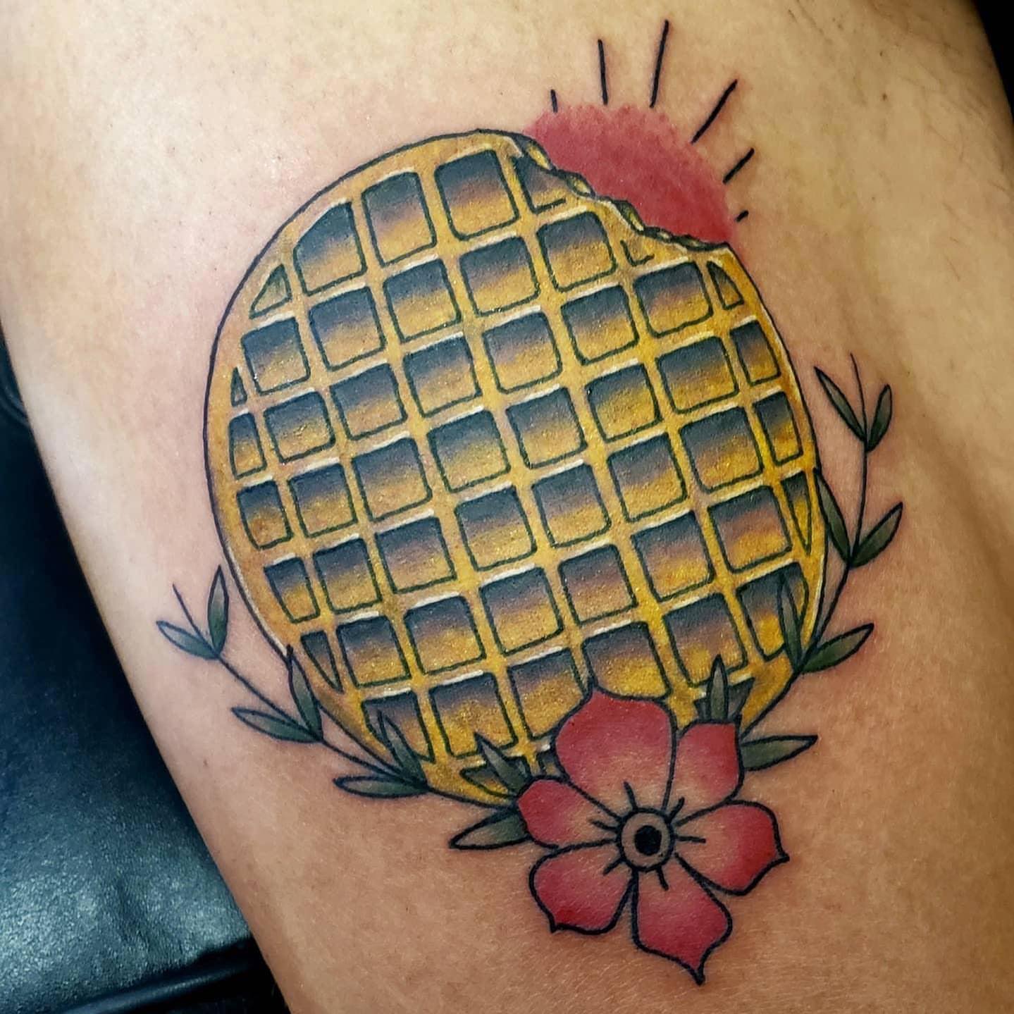 Waffle with flowers American traditional tattoo on the thigh by @tattoos_by_elijah