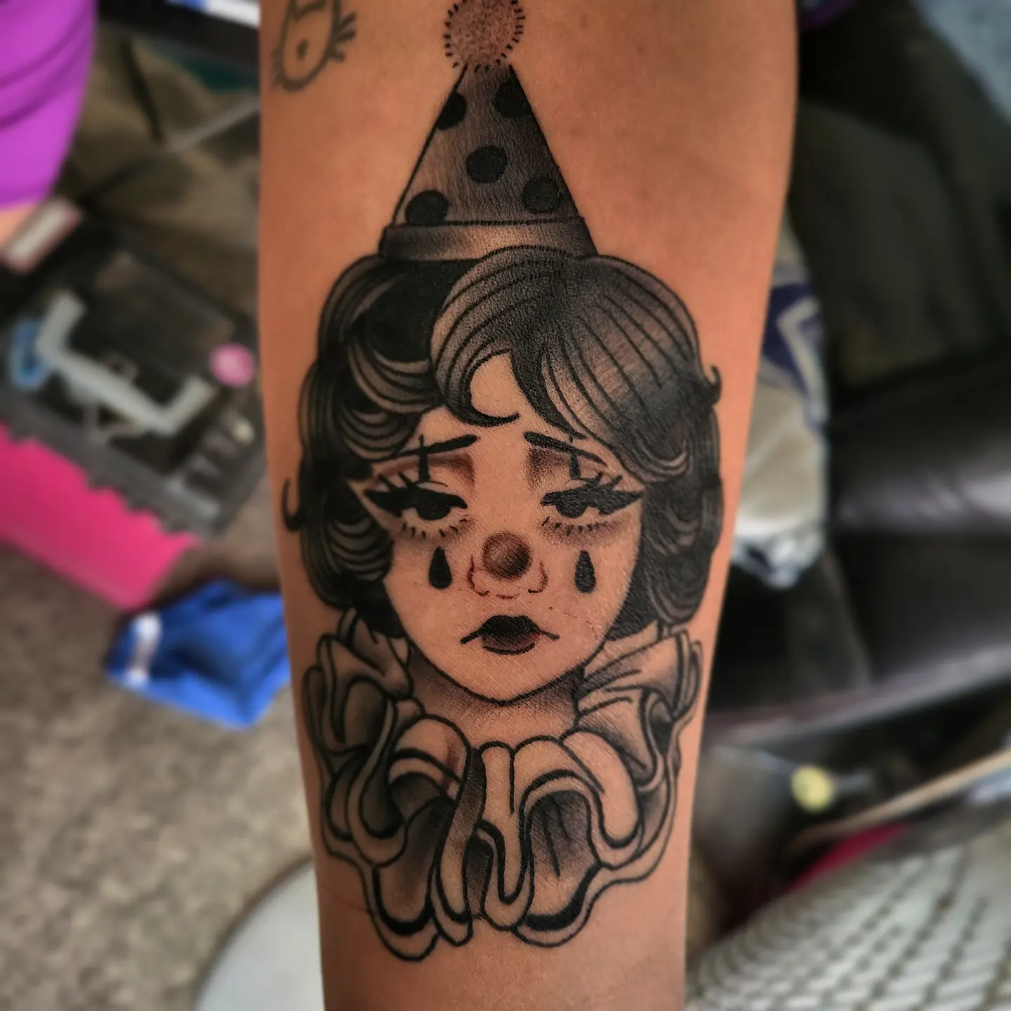 Clown black and grey tattoo on the forearm by TattoosbyPhatboi