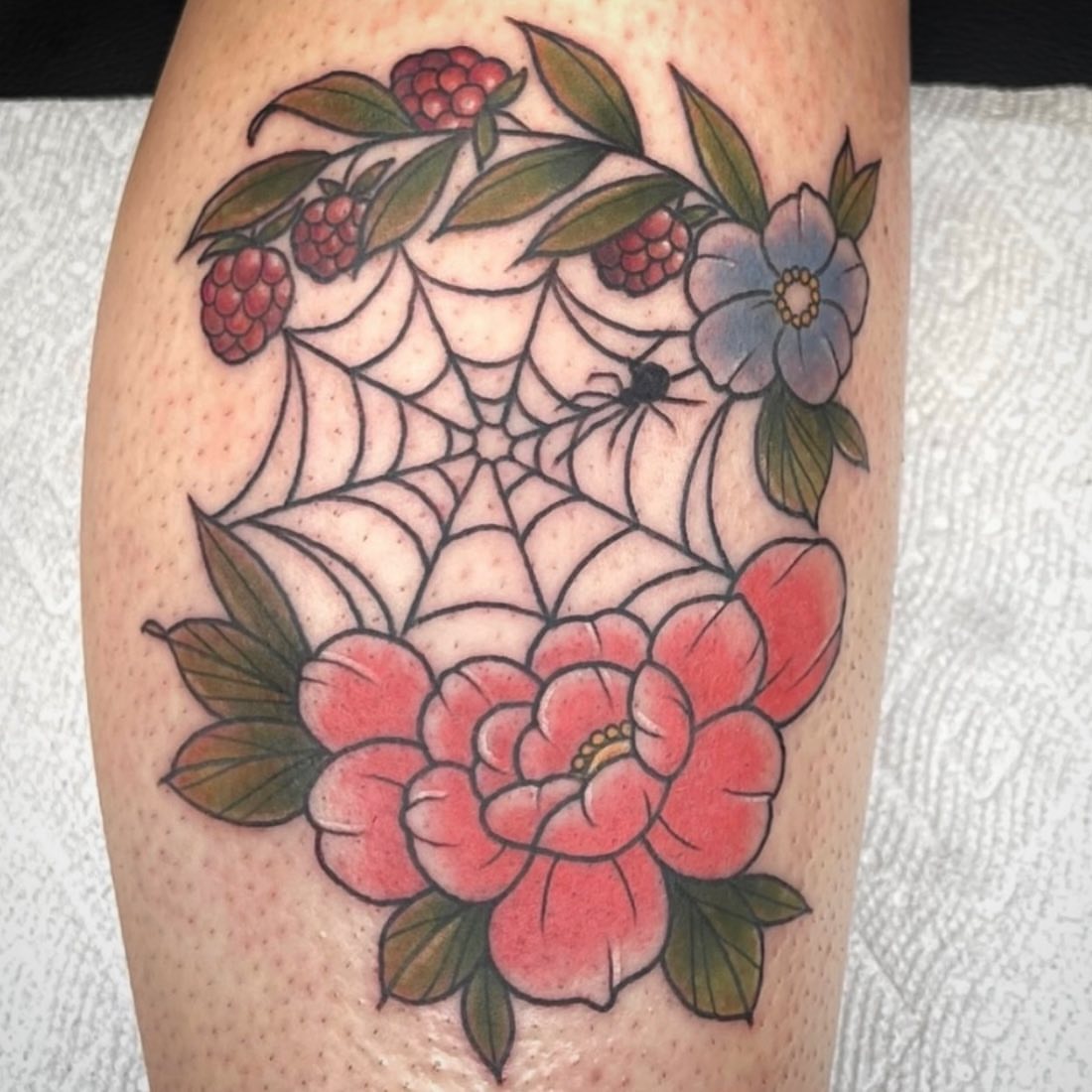 Flower and spider web American traditional tattoo on the thigh by Danielle Dubois