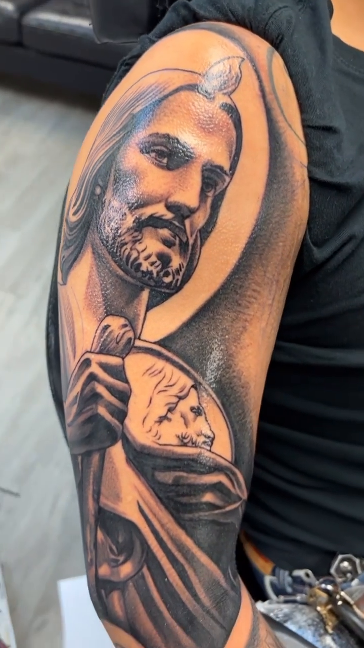 Jesus Christ holding a clock realism tattoo by Joseph Alvarado