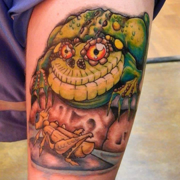 Monster and grasshopper American traditional tattoo on the thigh by Russell Lucas